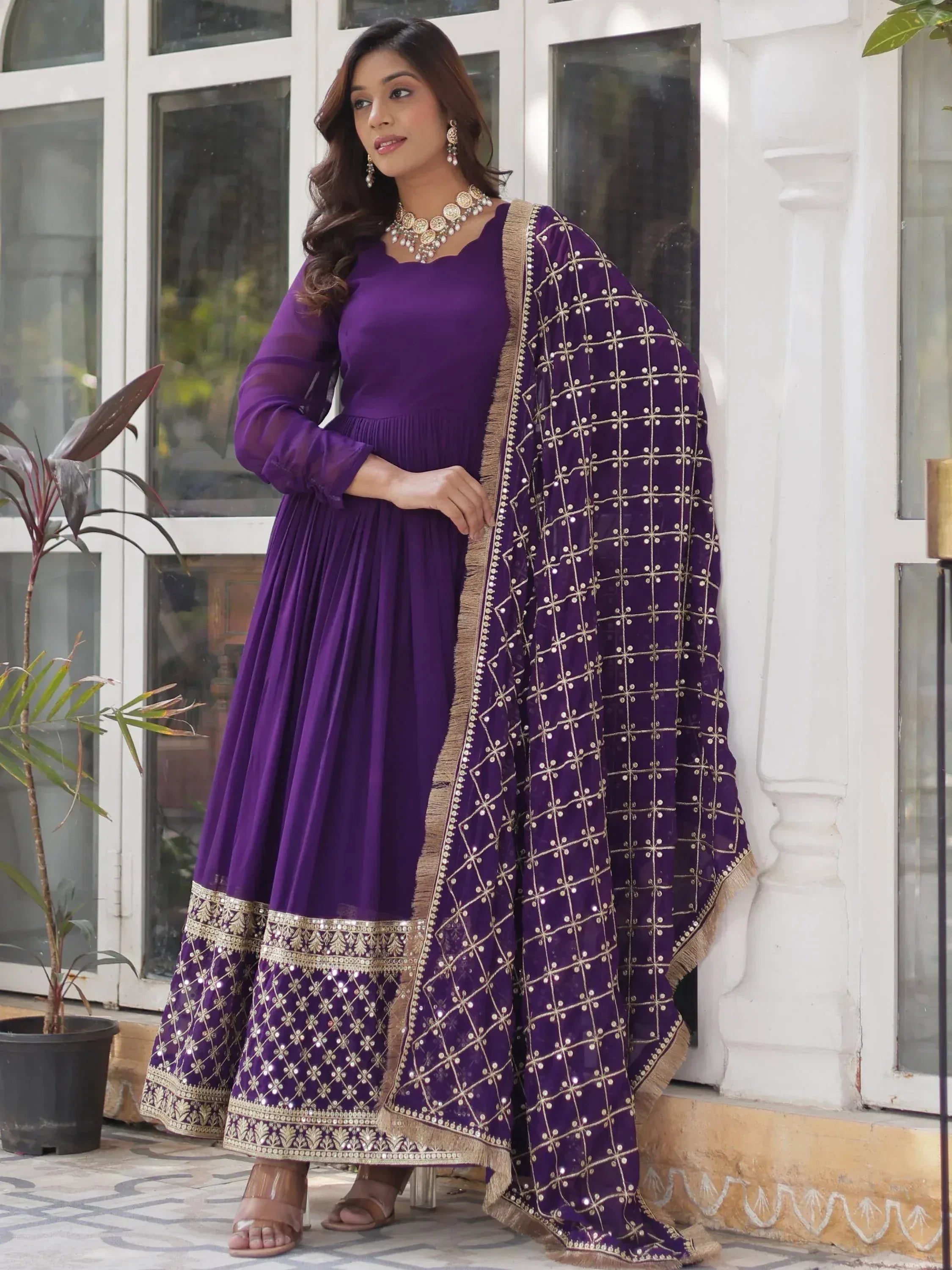 Purple ethnic anarkali suit with gold embroidery and matching dupatta, ideal for Indian occasions