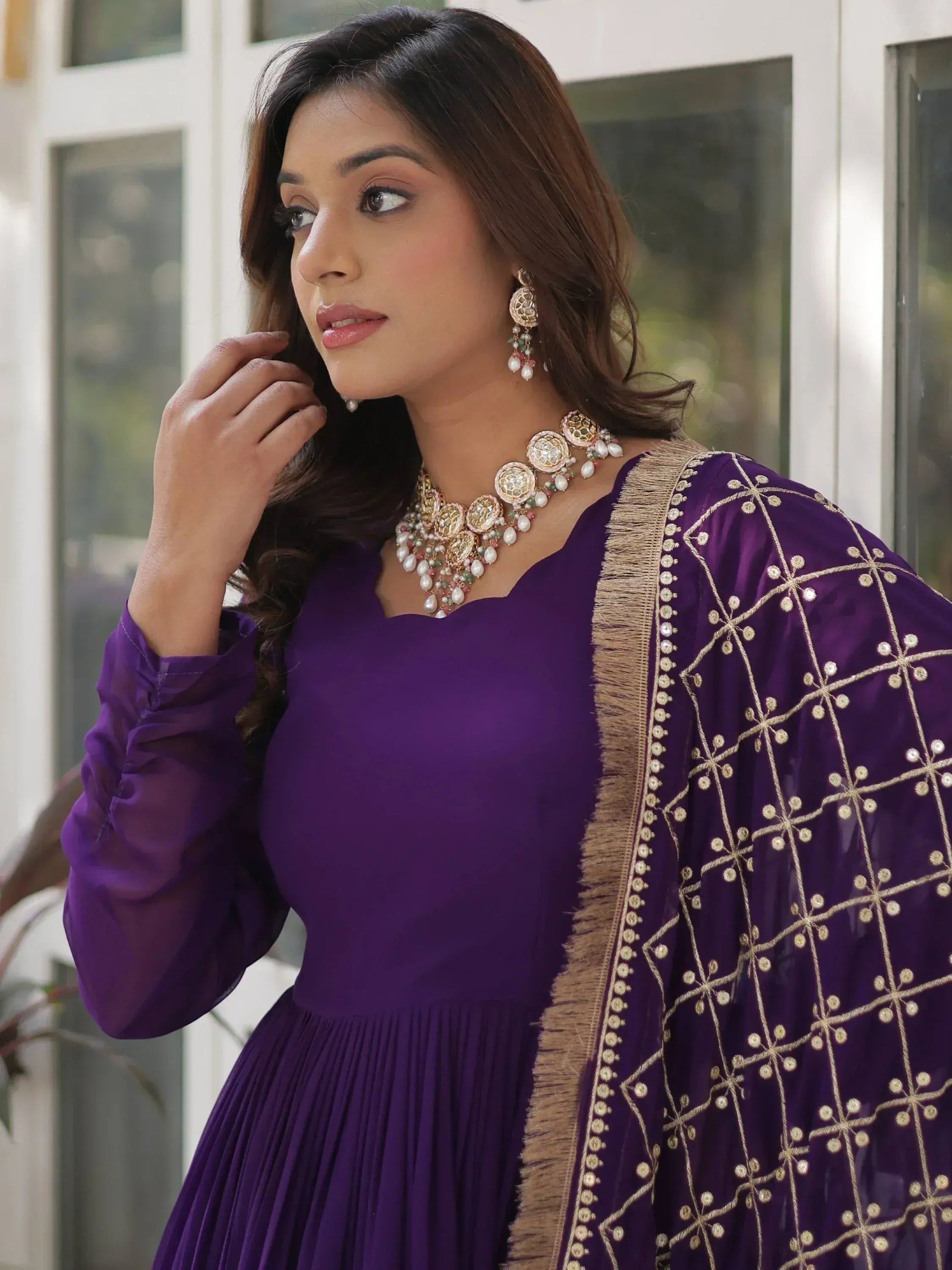 Purple ethnic gown with gold embroidery and matching jewelry for Indian wear