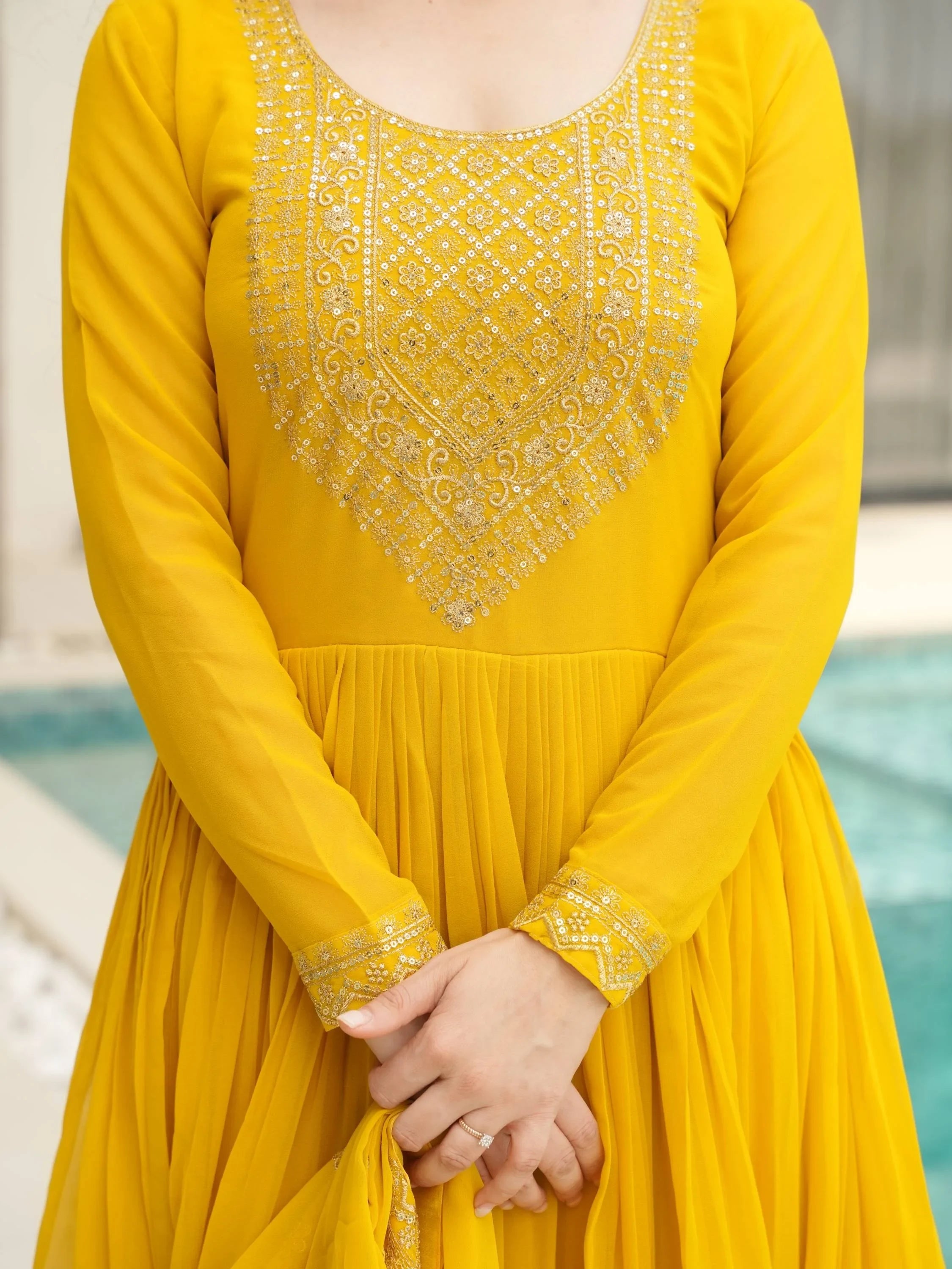 Yellow embroidered Anarkali suit with long sleeves and intricate sequin detailing