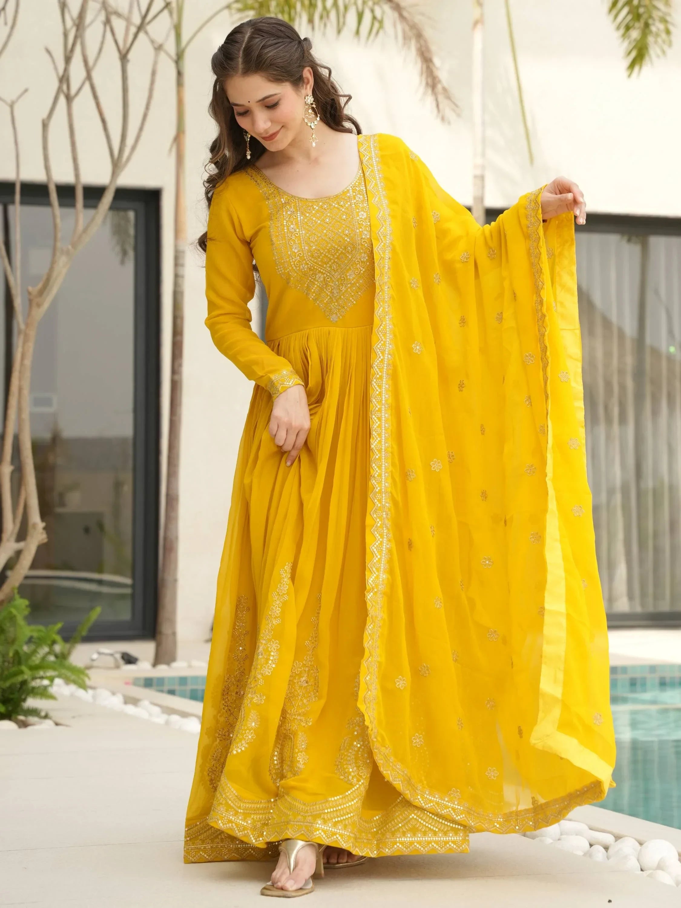 Woman wearing yellow embroidered Anarkali suit with dupatta, Indian ethnic outfit