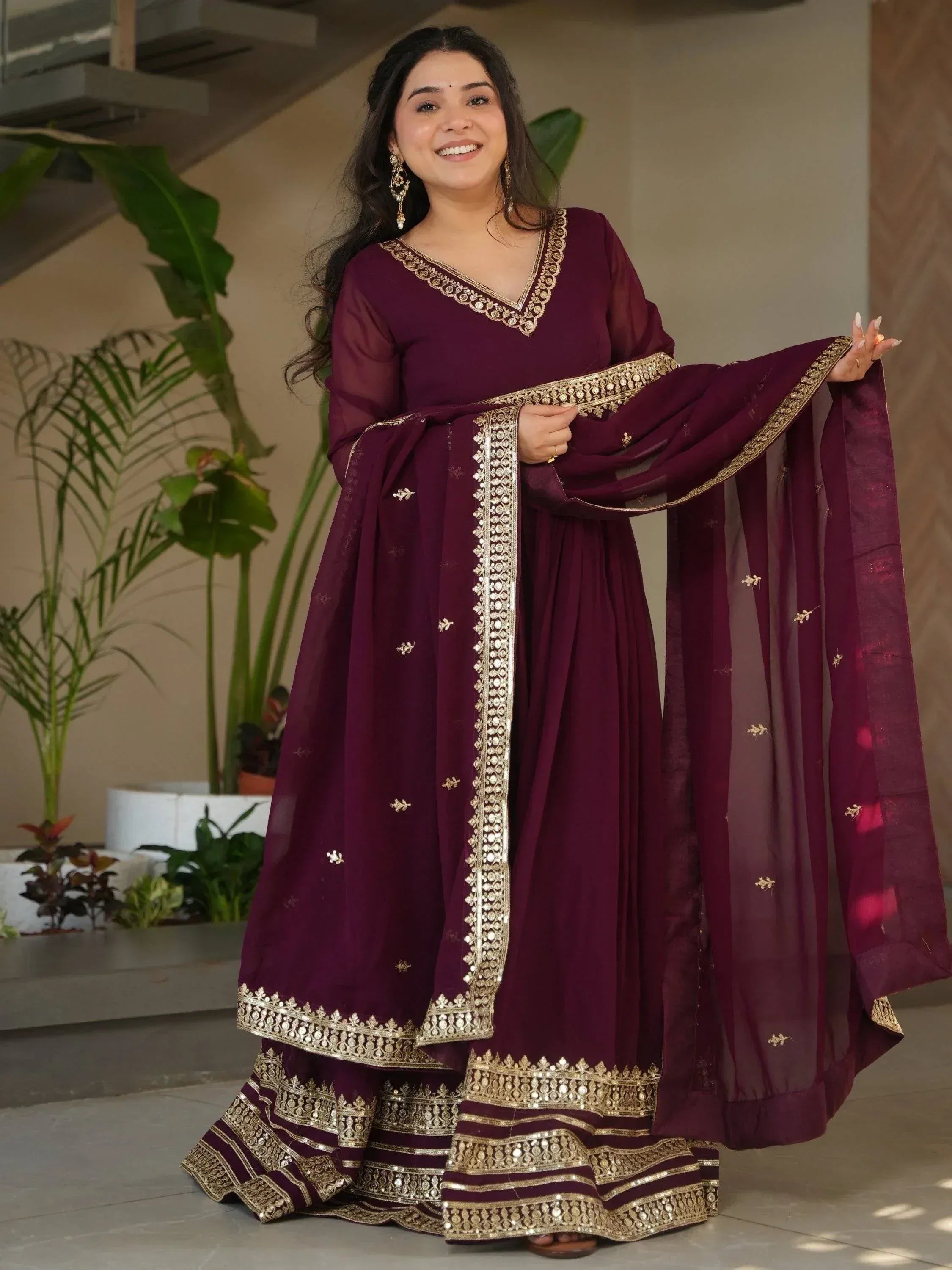 Elegant maroon salwar kameez with gold embroidery, perfect for Indian ethnic wear occasions.