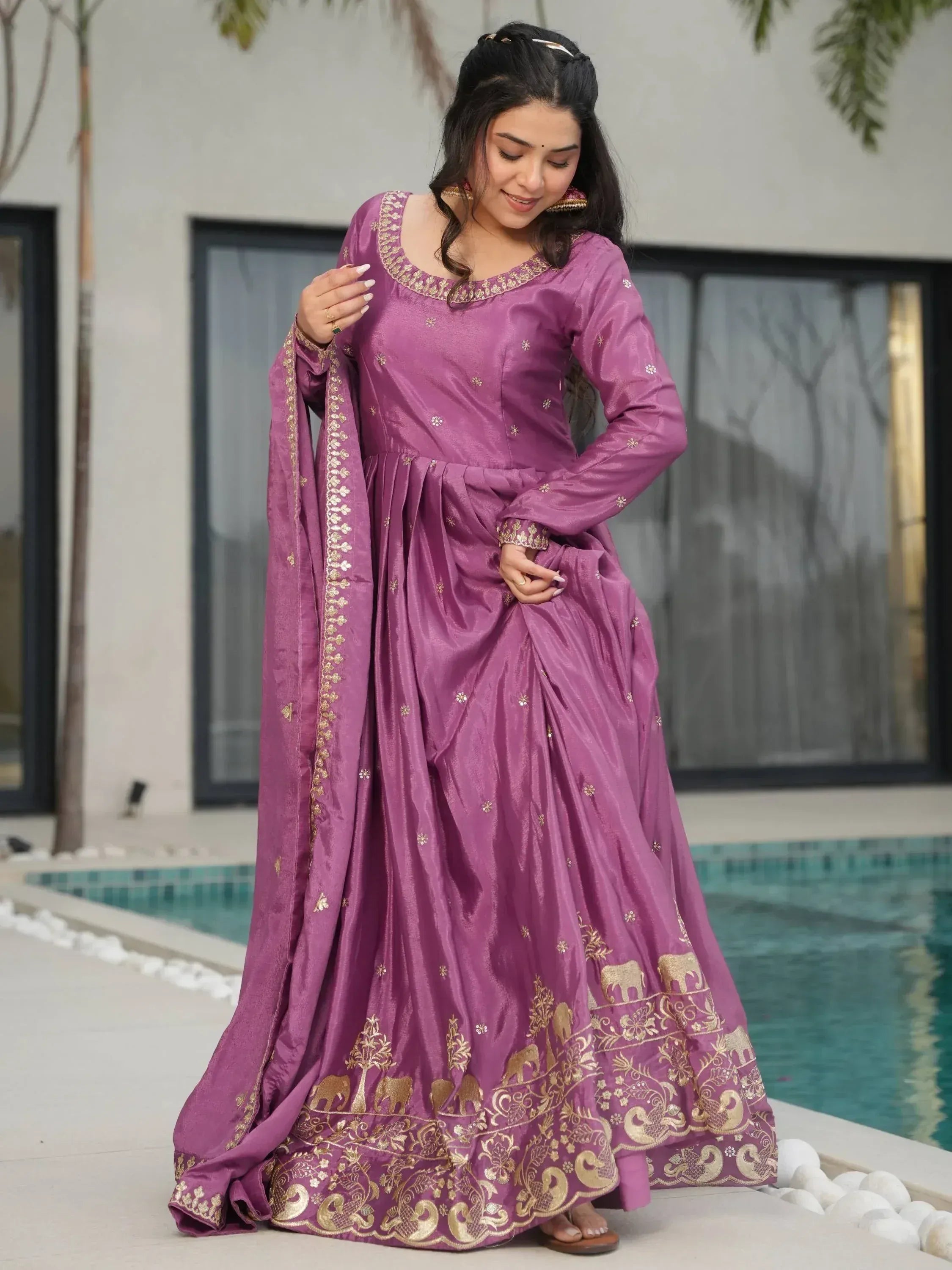 Purple ethnic gown with gold elephant embroidery, perfect for Indian festive occasions