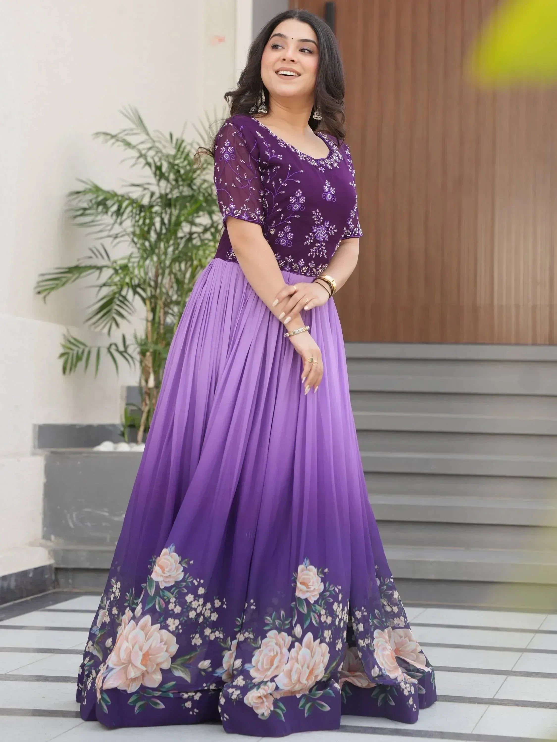 Purple floral ethnic gown with embroidered top and pleated skirt, perfect for Indian occasions