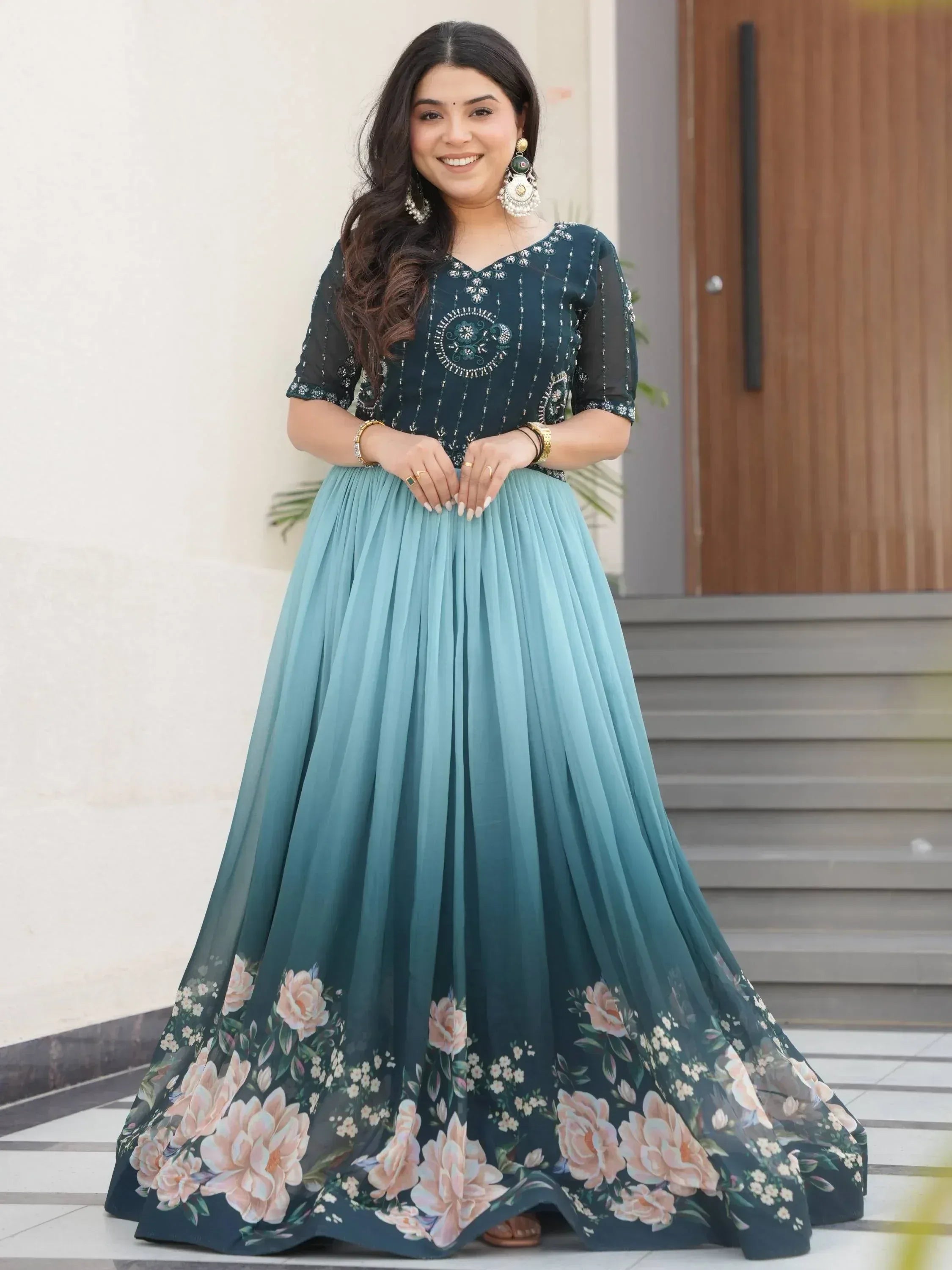 Woman in elegant teal floral ethnic gown with embroidered top, perfect for Indian occasions