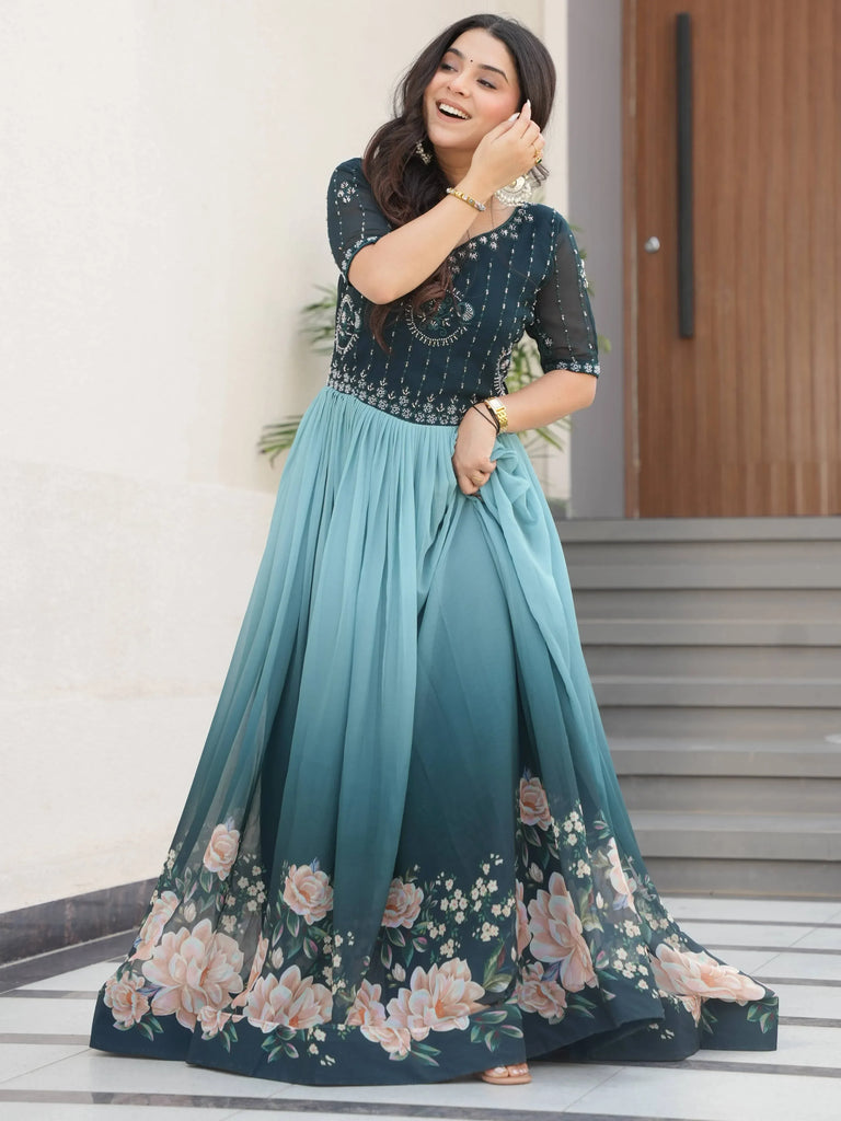 Woman in teal floral ethnic gown with embroidered top, perfect for Indian occasions