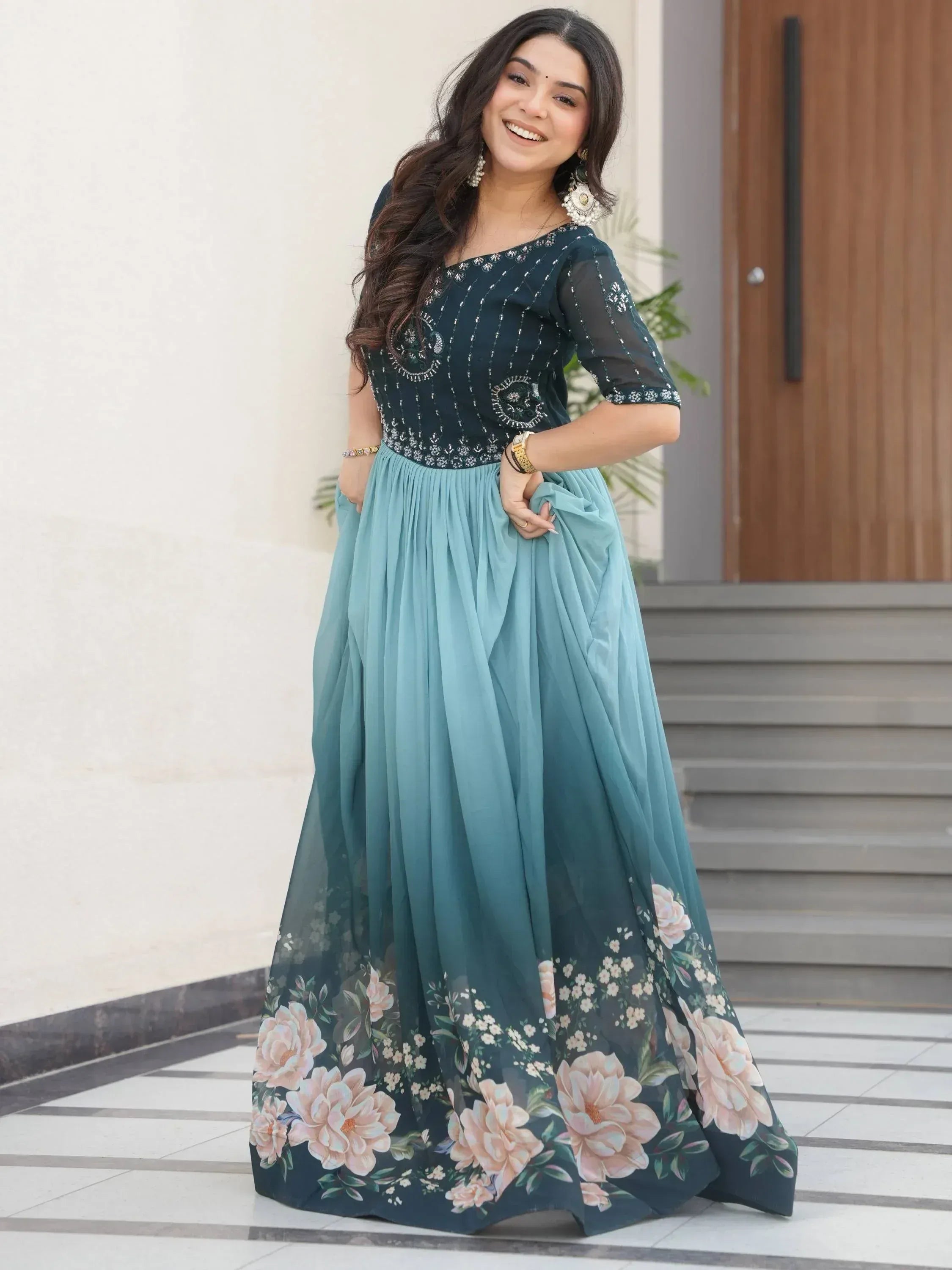 Woman in elegant teal floral ethnic gown with embroidered bodice, perfect for Indian occasions