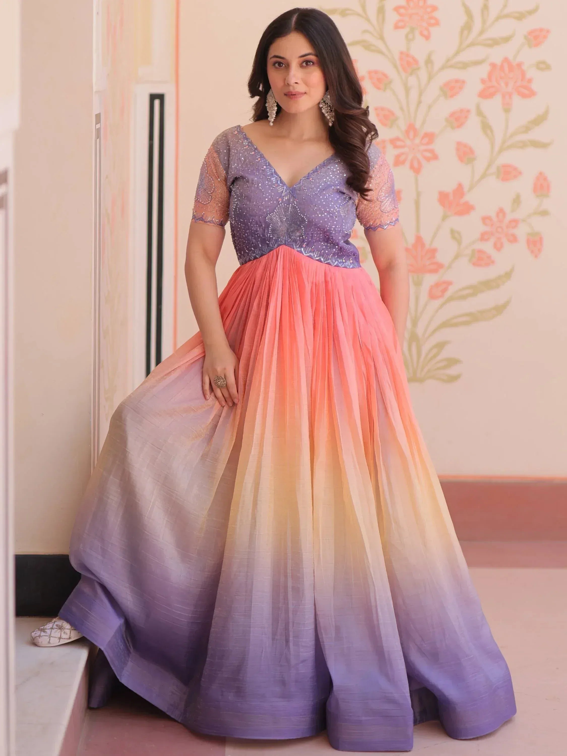 Woman in purple and pink ombre ethnic gown with sequin top, perfect for Indian occasions