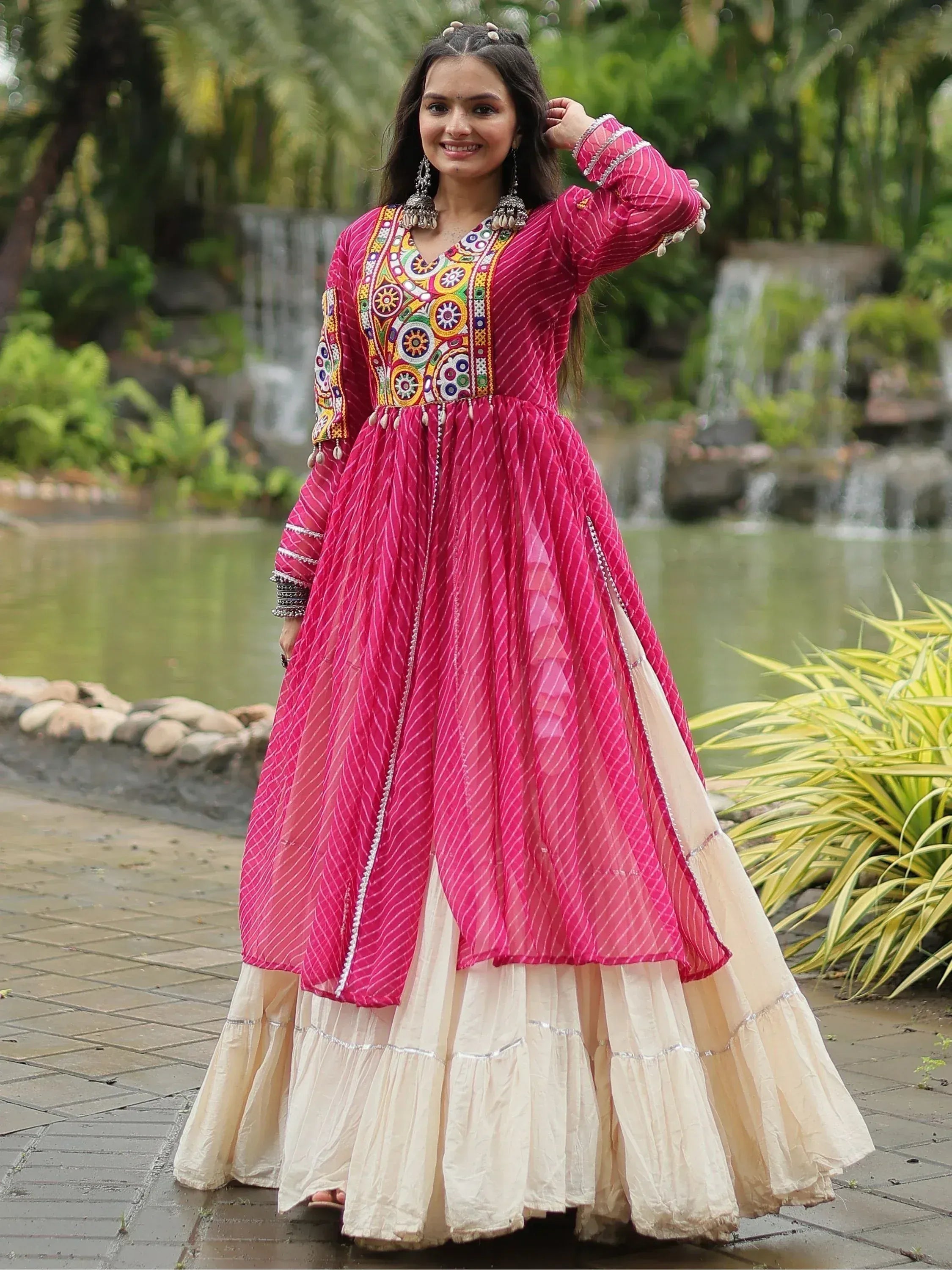 Pink embroidered ethnic gown with layered skirt, perfect for festive occasions and traditional events.