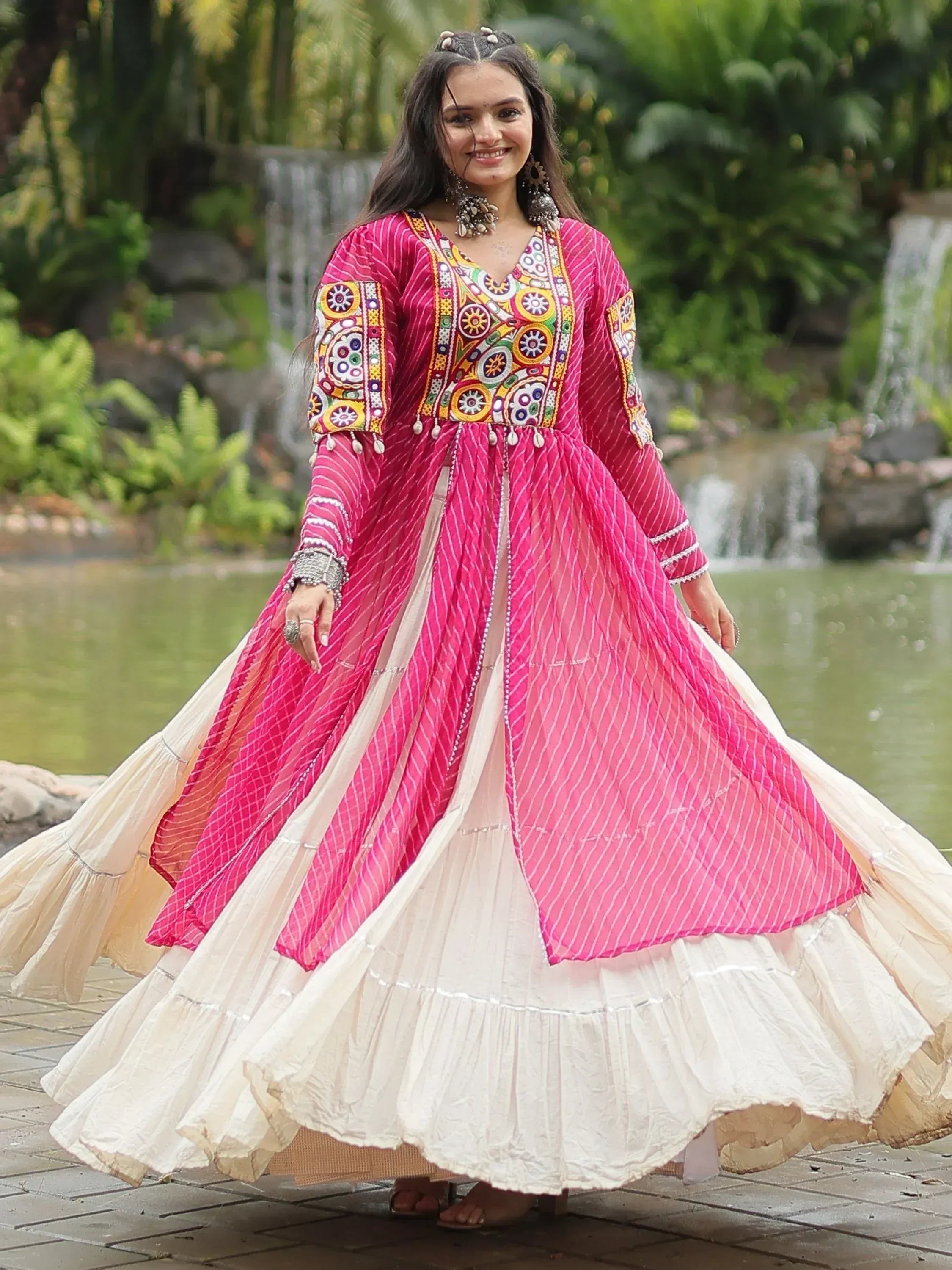 Pink embroidered ethnic gown with white ruffled skirt, perfect for Indian festive occasions