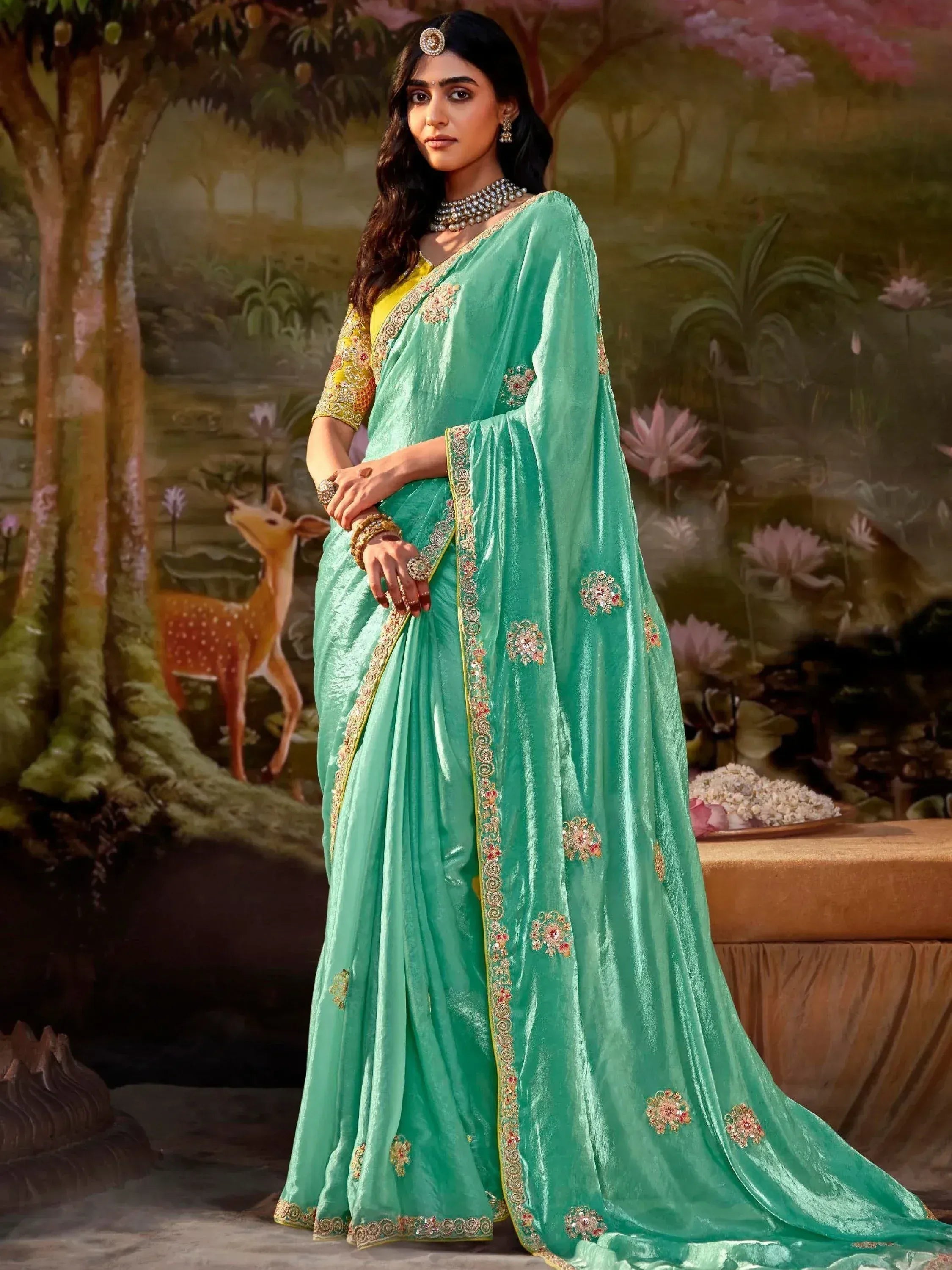 Mint green velvet saree with gold embroidery, floral motifs, and yellow blouse, styled with traditional jewelry for Indian ethnic wear.