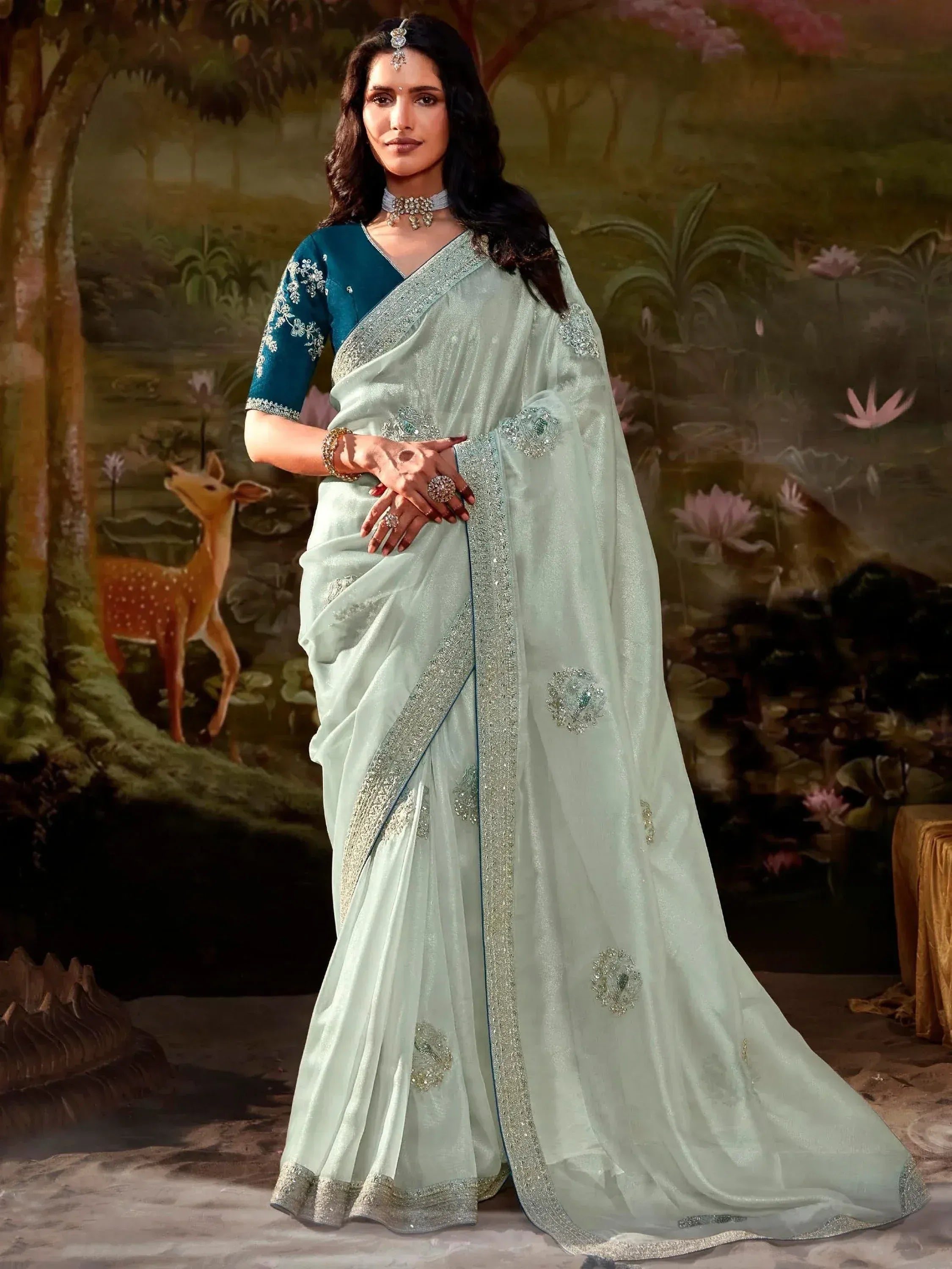 Elegant mint green saree with silver embroidery, paired with teal blouse, perfect for Indian ethnic occasions.