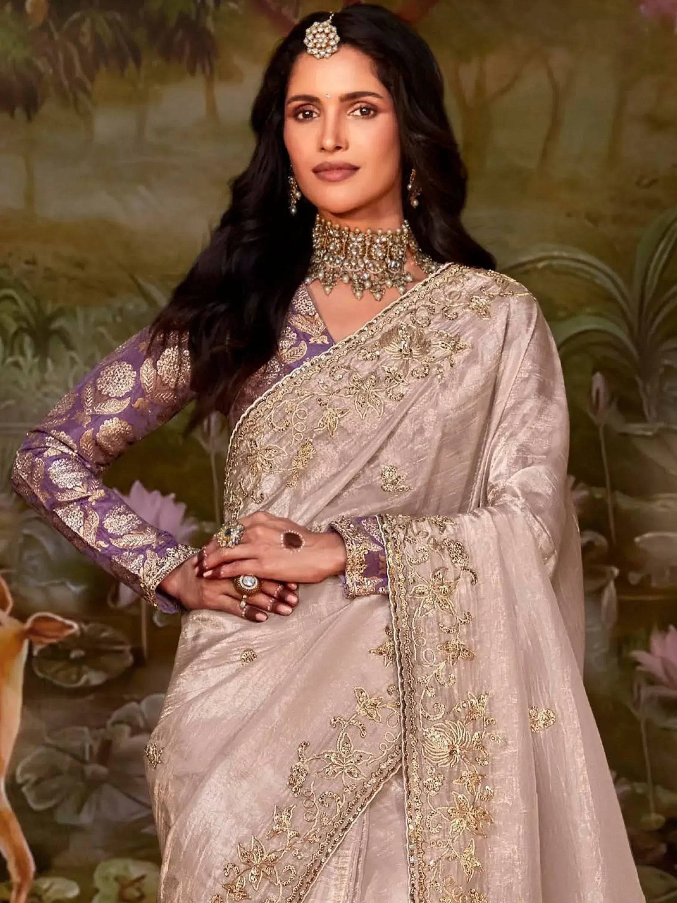 Elegant Indian ethnic saree with gold embroidery, purple blouse, and traditional jewelry for festive occasions