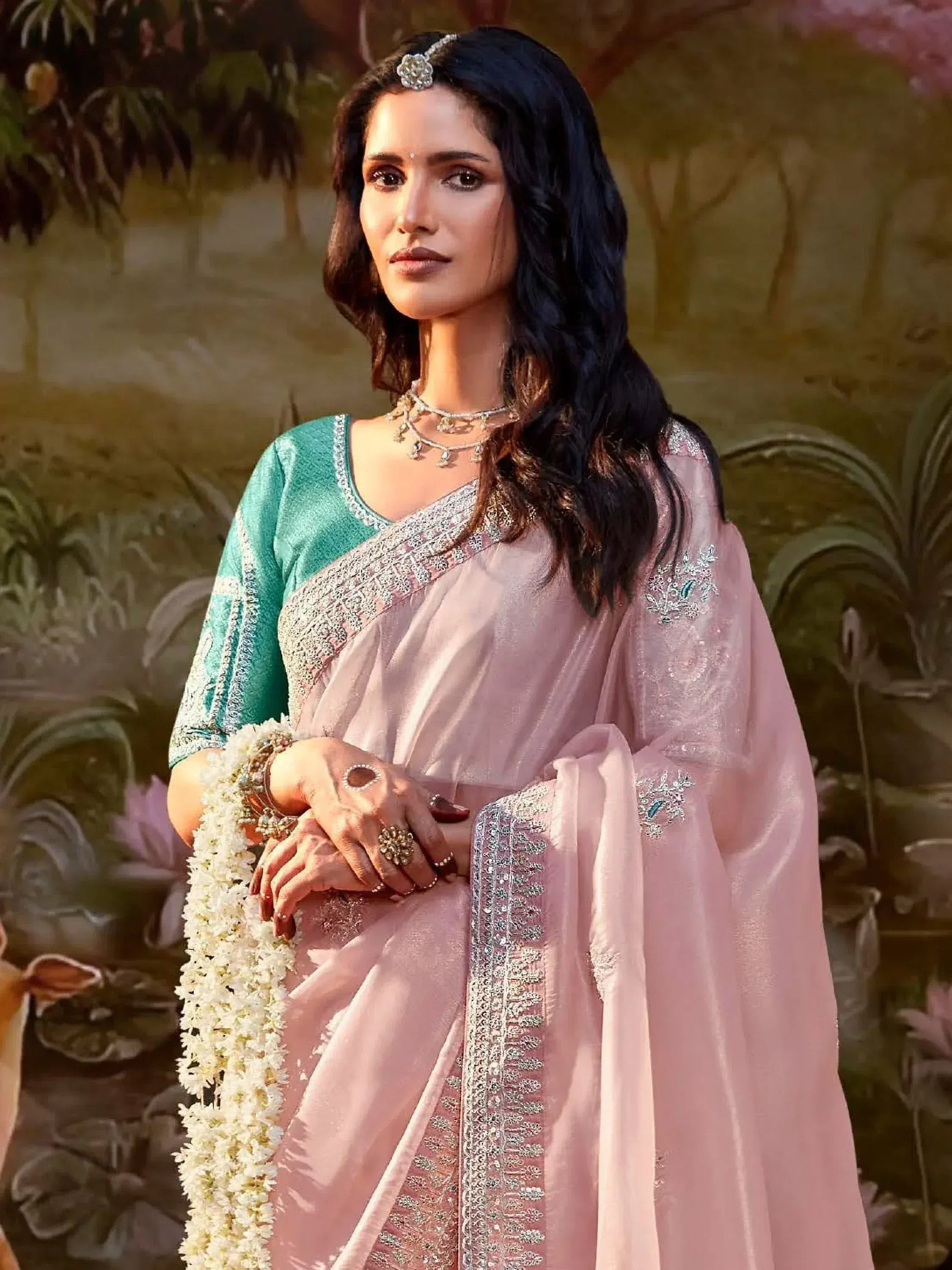 Elegant pink and teal embroidered saree with traditional jewelry, perfect for Indian ethnic occasions