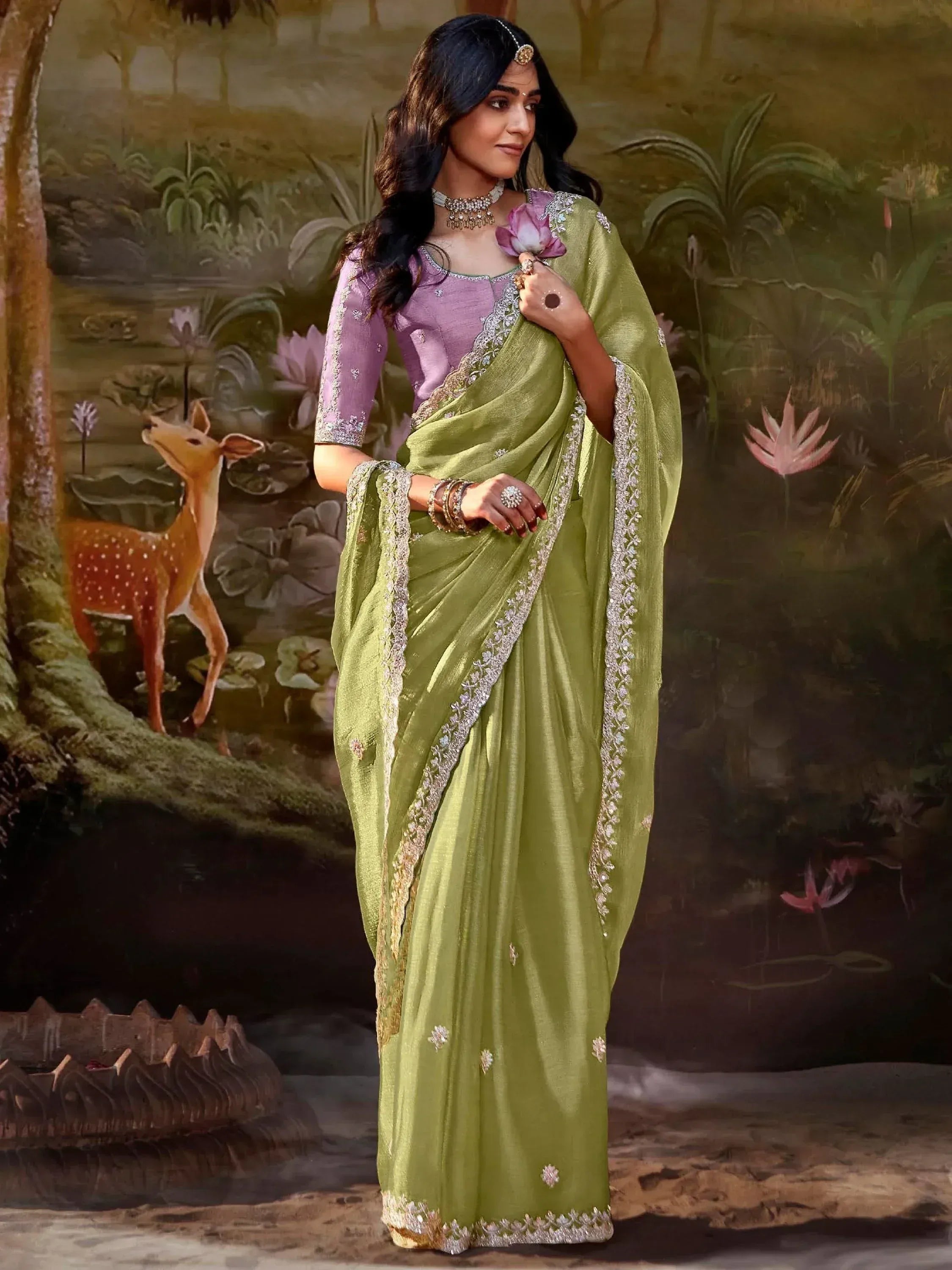 Woman in olive green embroidered saree with purple blouse, traditional Indian ethnic wear