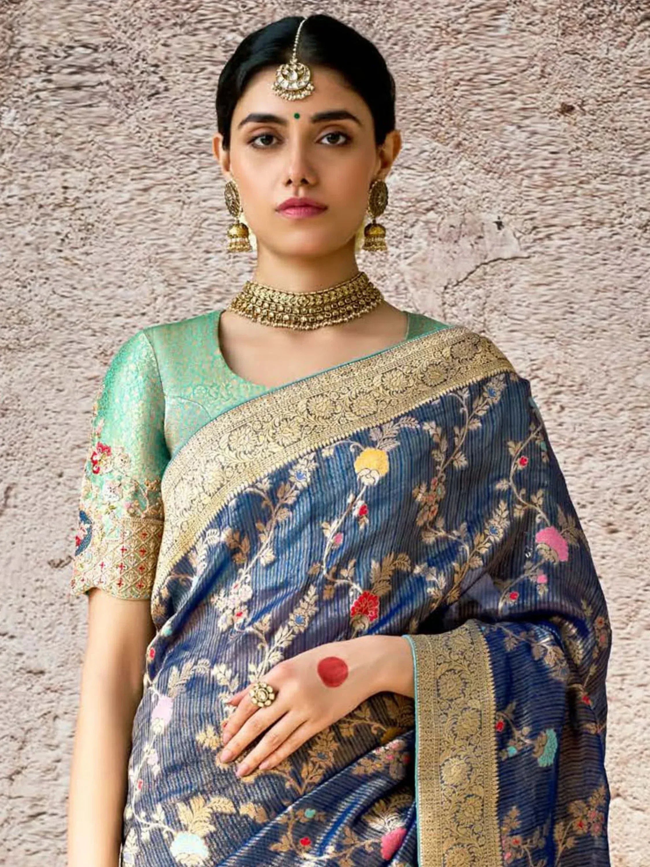 Woman in blue floral saree with gold border and green blouse, traditional Indian ethnic wear
