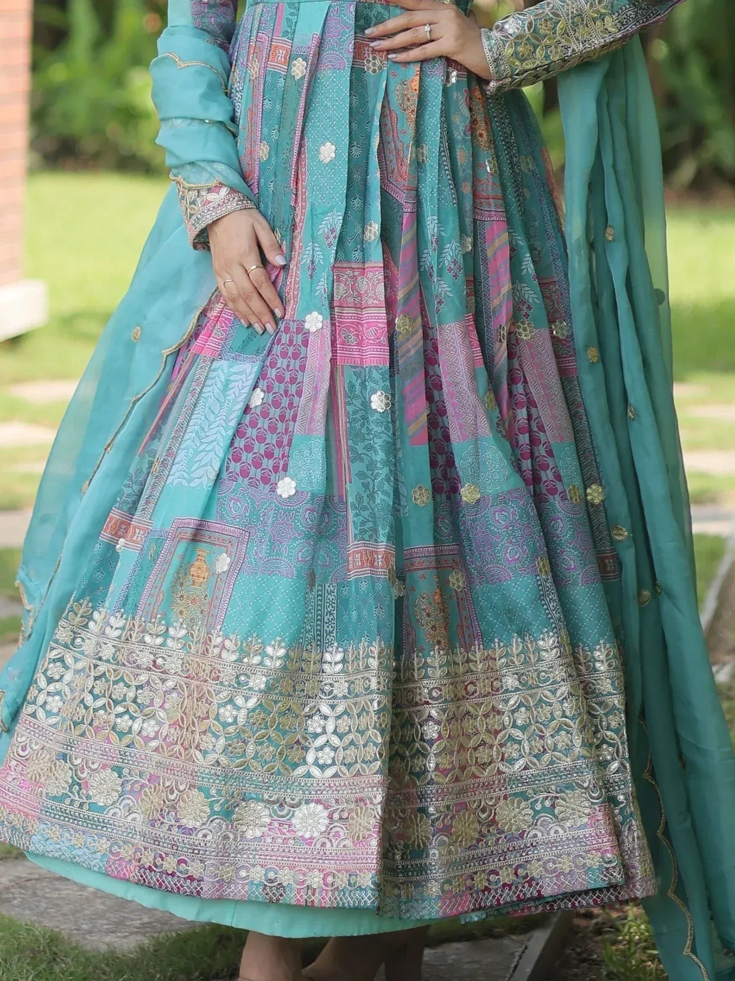Teal and pink patchwork lehenga with intricate embroidery, perfect for Indian ethnic wear occasions