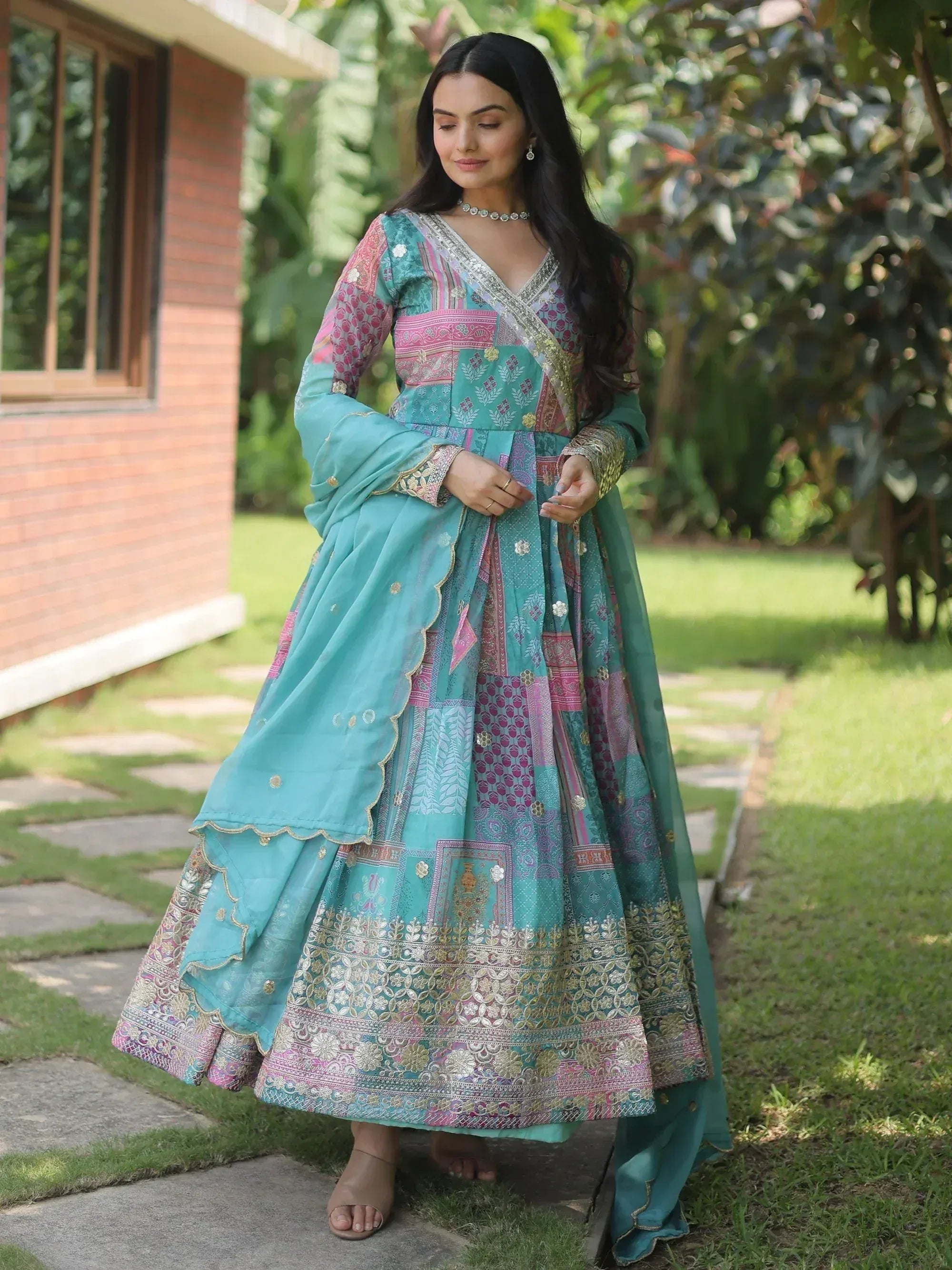 Turquoise and pink patchwork designer lehenga choli with gold embroidery, perfect for Indian ethnic wear occasions.