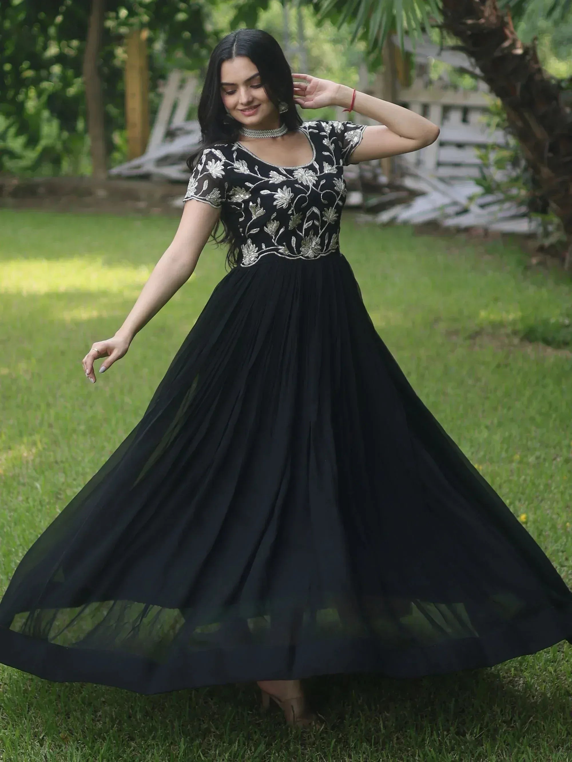 Black ethnic gown with silver floral embroidery, flowing pleated skirt, perfect for Indian occasions