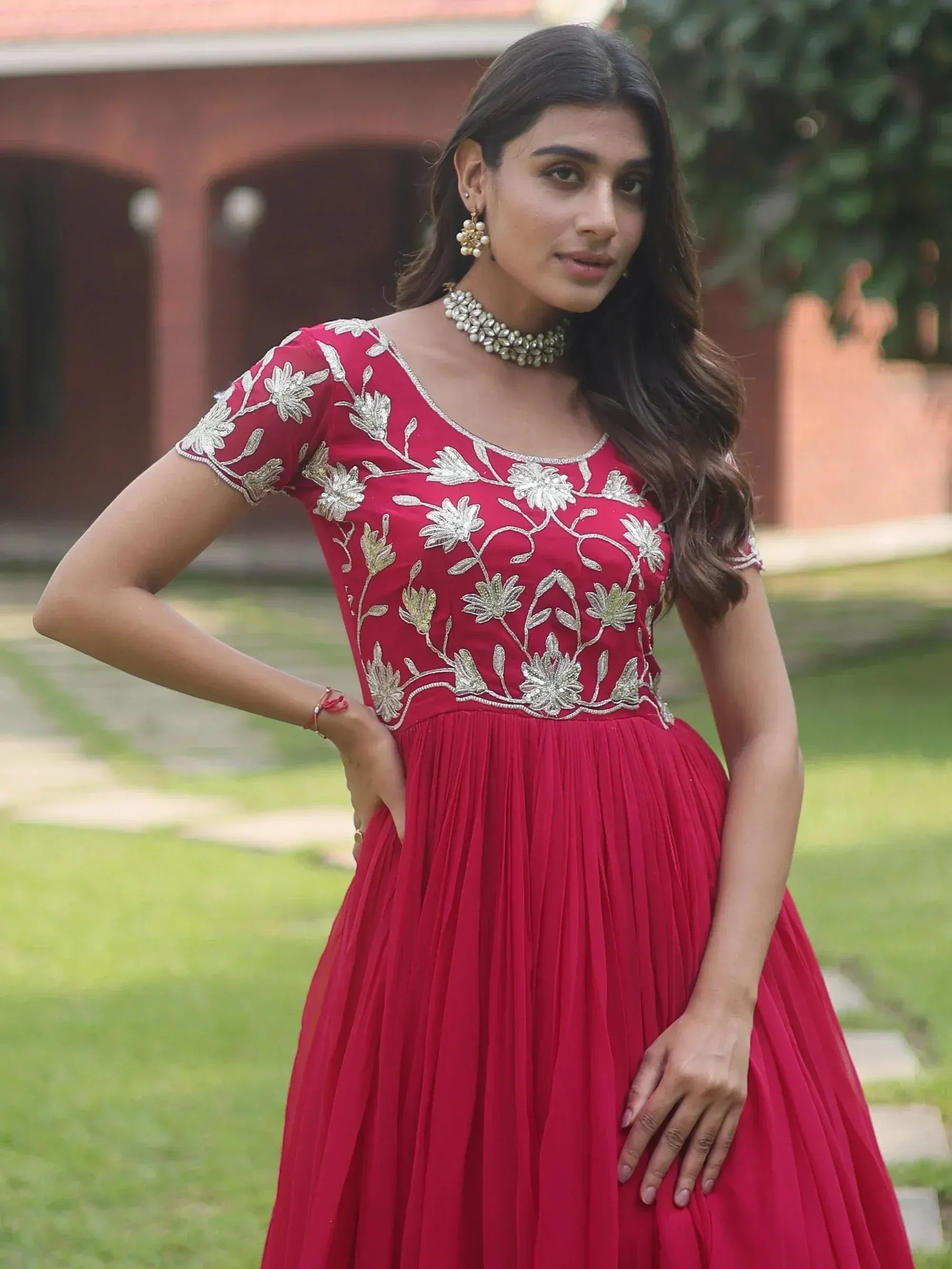 Red ethnic gown with silver floral embroidery, perfect for Indian celebrations and events.
