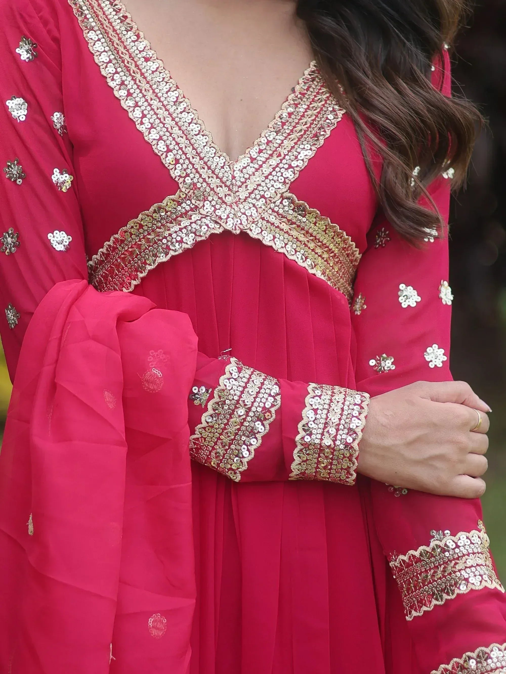 Red ethnic gown with gold sequin embroidery, V-neckline, and flared sleeves for festive occasions