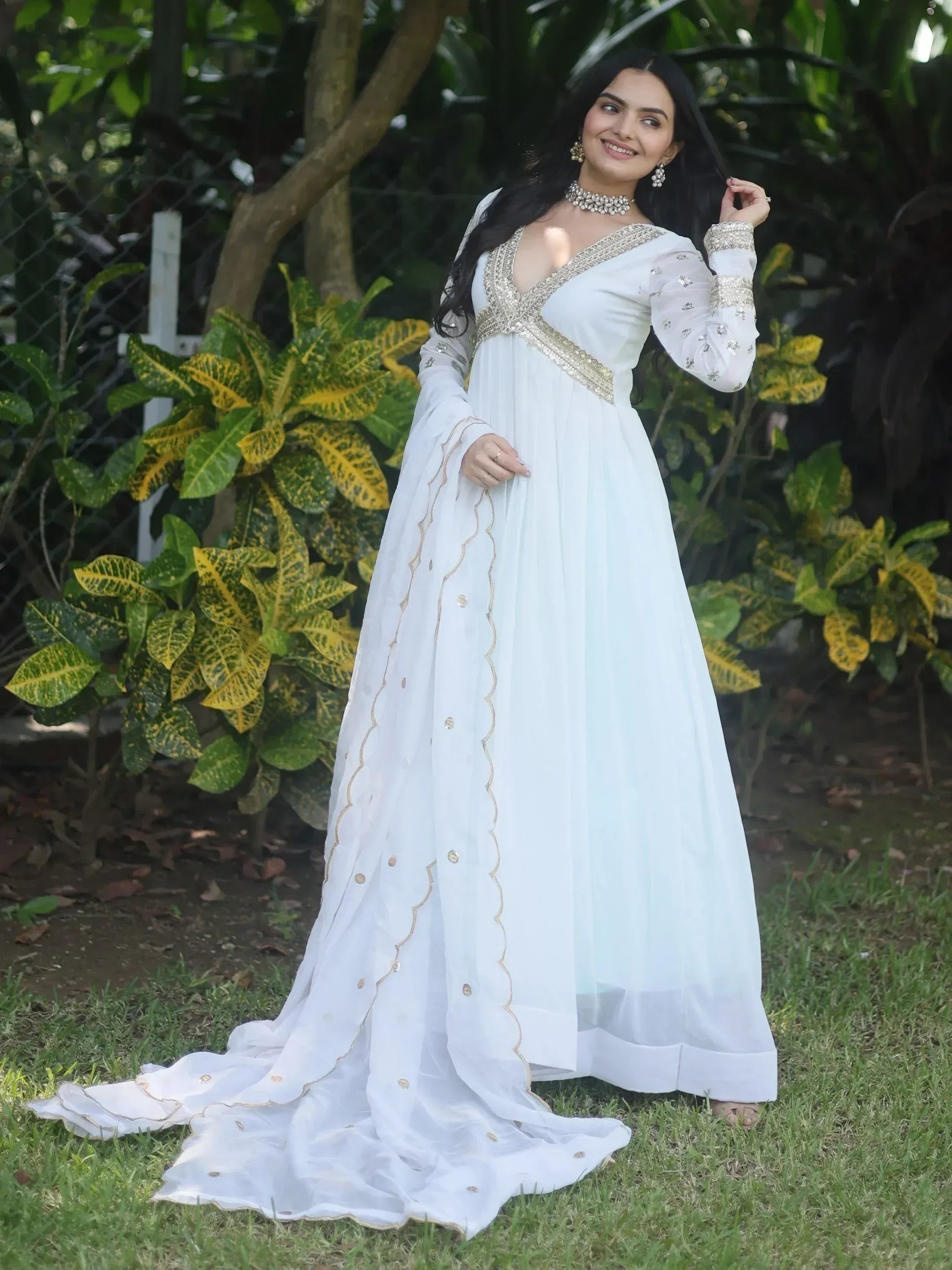 White ethnic gown with gold embroidery, perfect for Indian weddings and festive occasions