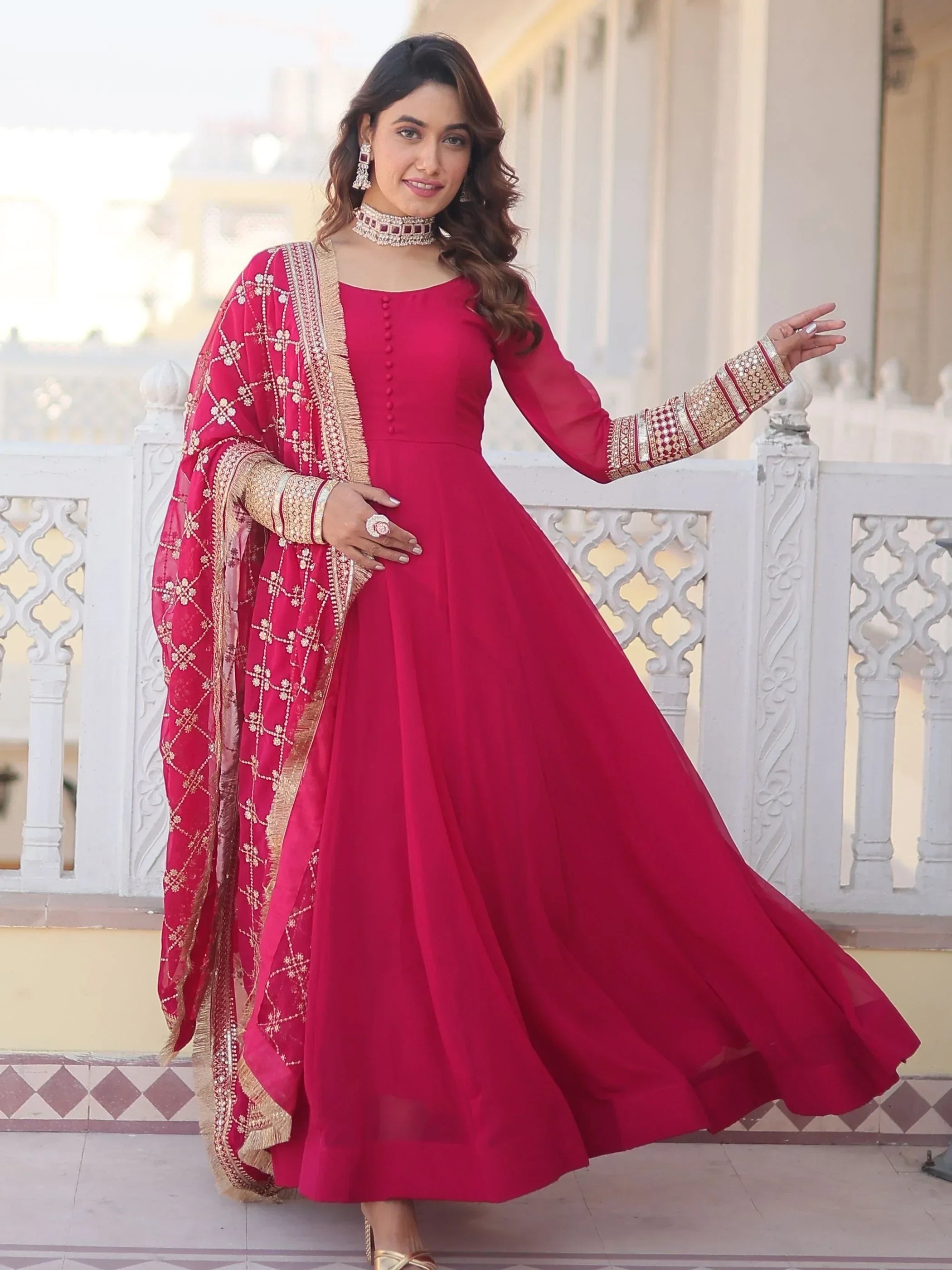 Woman in a pink Anarkali suit with embroidered dupatta, traditional Indian ethnic wear