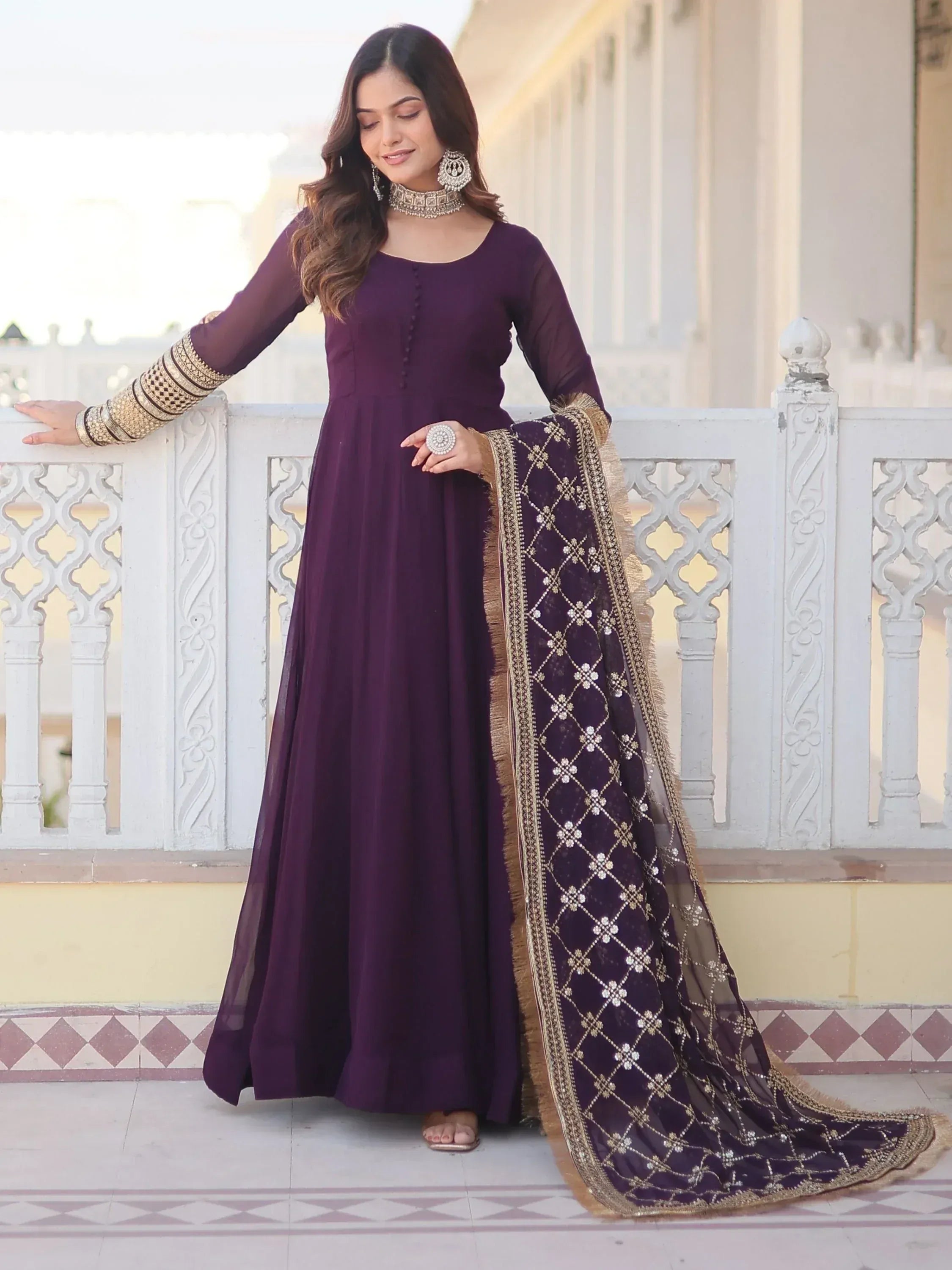 Purple ethnic gown with gold embroidery and matching dupatta, perfect for Indian occasions