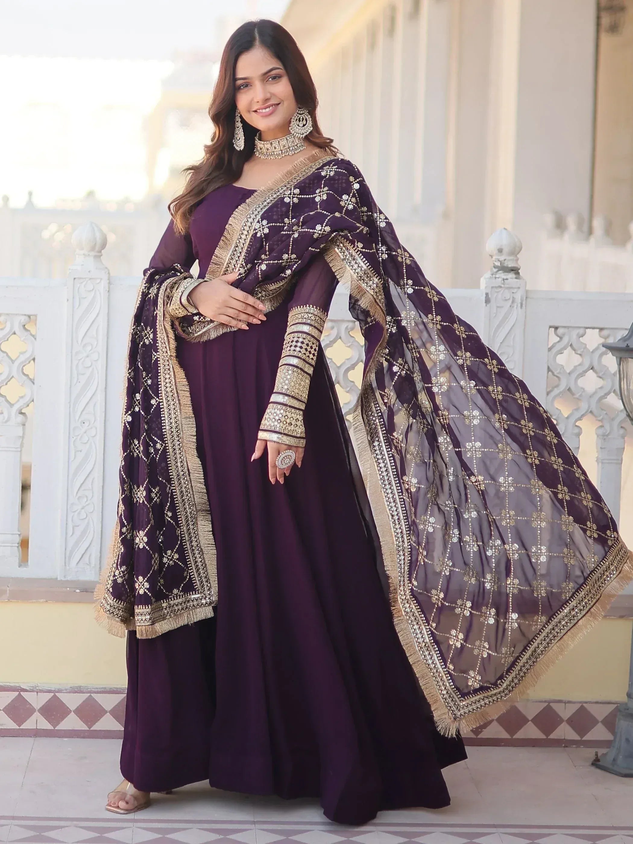 Purple ethnic gown with gold embroidery and matching dupatta, perfect for Indian occasions