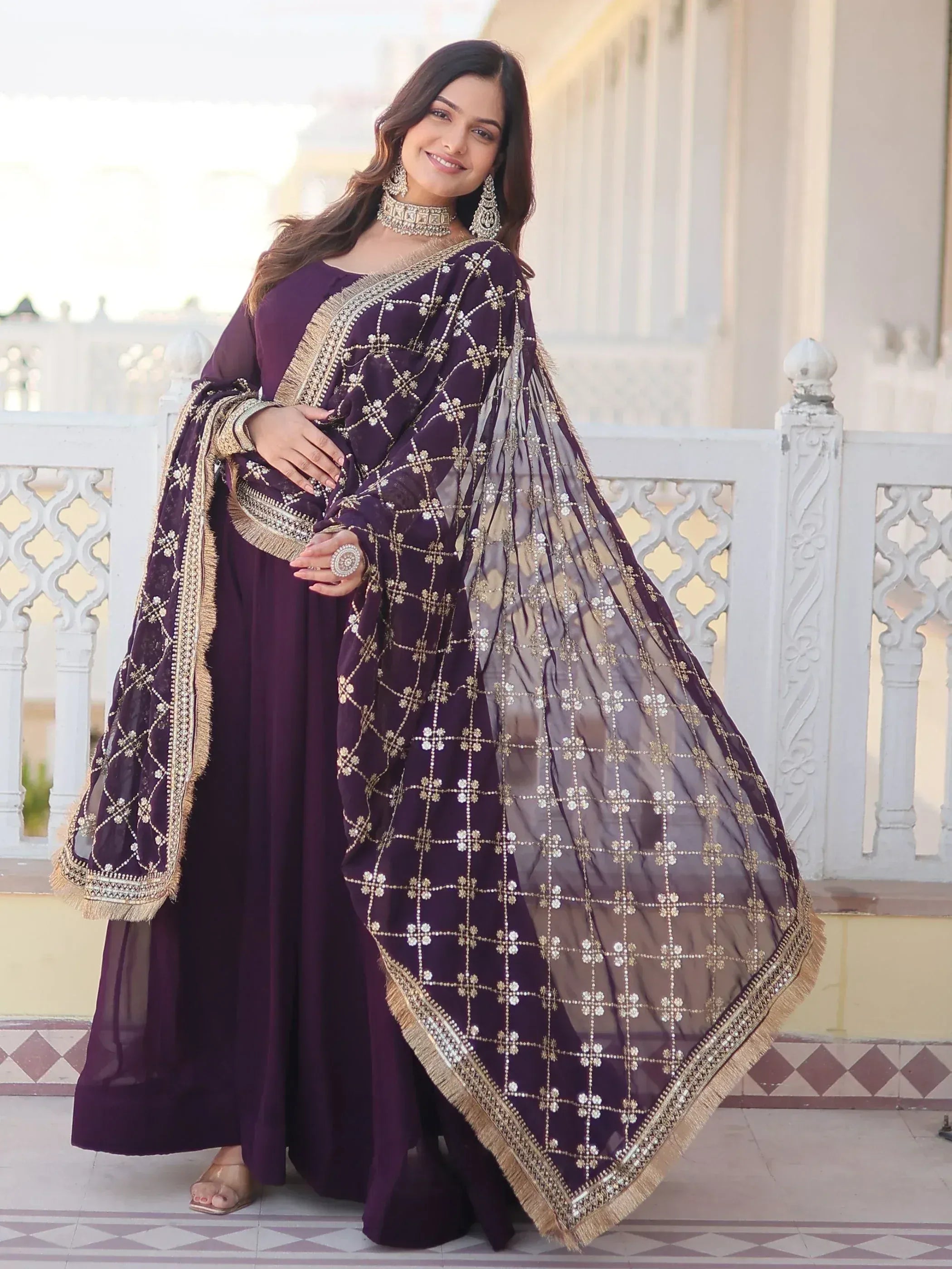 Purple embroidered ethnic gown with gold detailing, perfect for Indian weddings and festive occasions