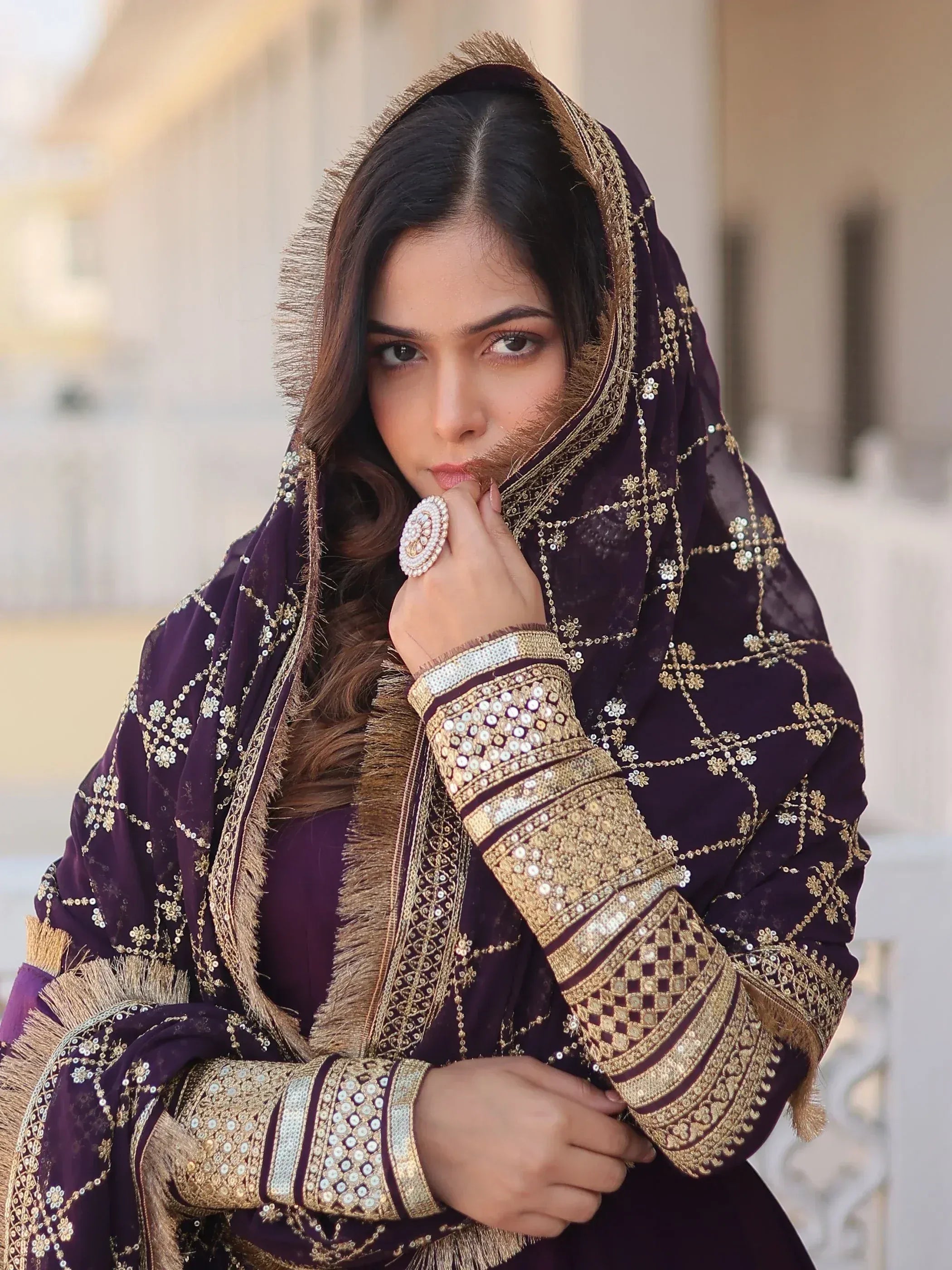Elegant purple ethnic wear with gold embroidery and sequins, perfect for festive occasions
