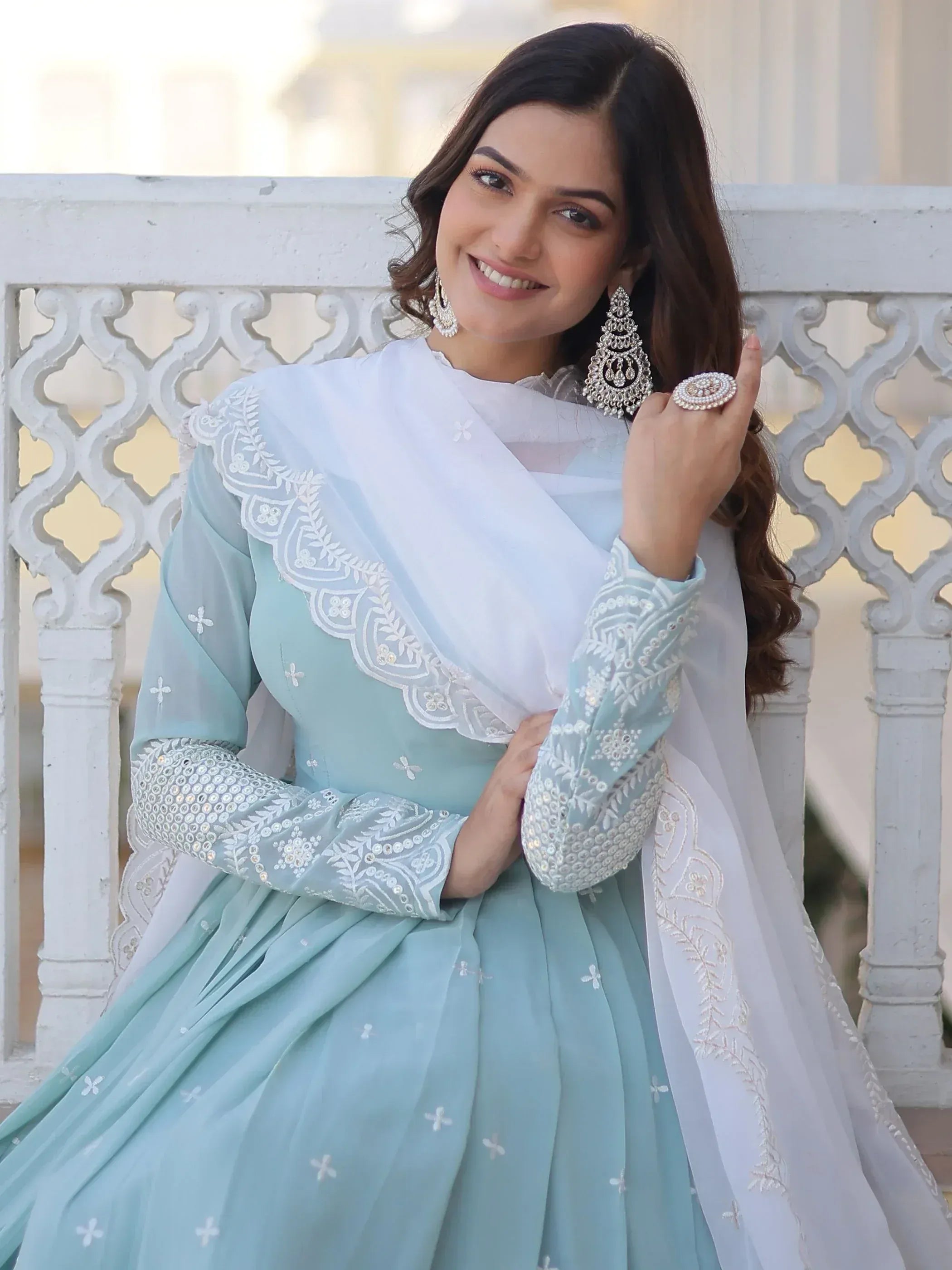 Woman in light blue embroidered salwar kameez with white dupatta, ethnic Indian wear