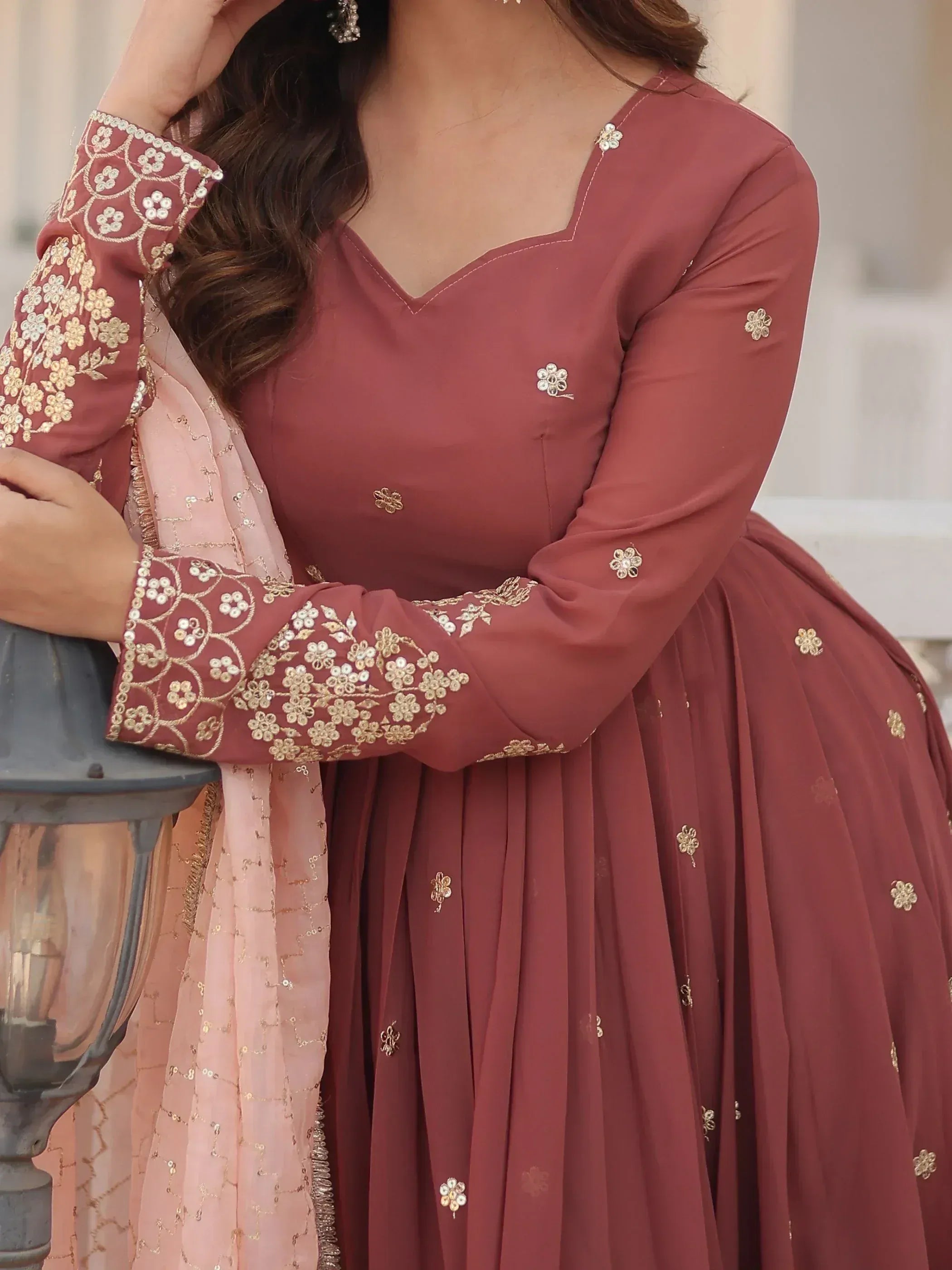 Dusty rose Indian ethnic gown with gold floral embroidery, paired with sheer pink dupatta for festive occasions