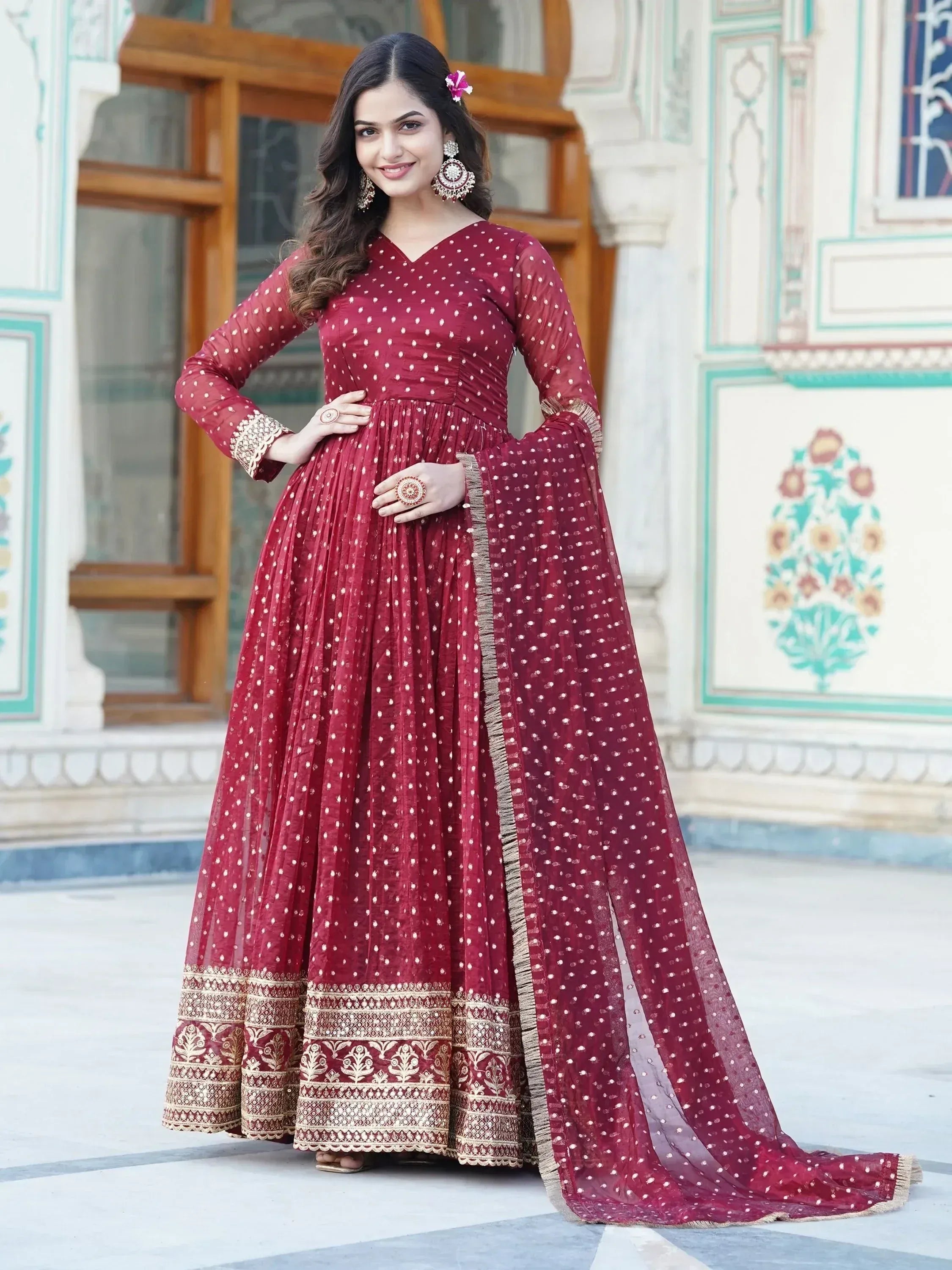 Maroon ethnic gown with gold embroidery, perfect for Indian weddings and festive occasions