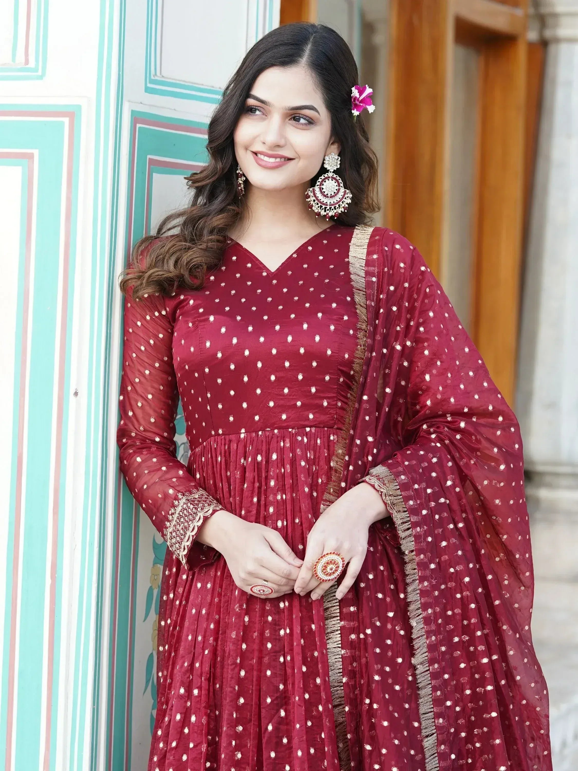 Maroon ethnic gown with white polka dots, gold trim, and matching dupatta for Indian occasions