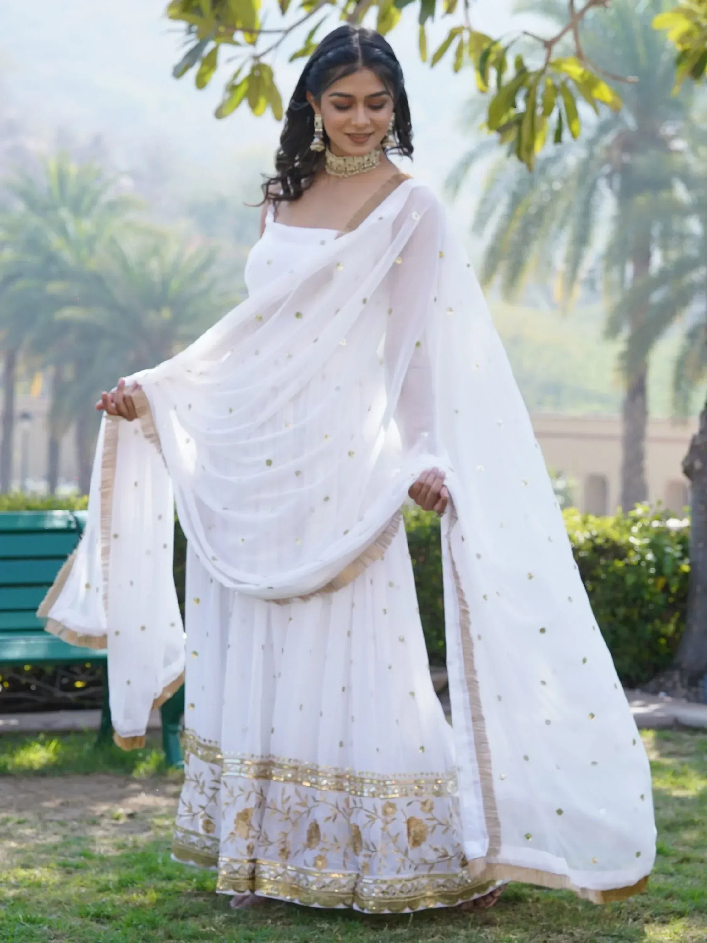 White embroidered lehenga choli with gold detailing, perfect for Indian ethnic wear occasions