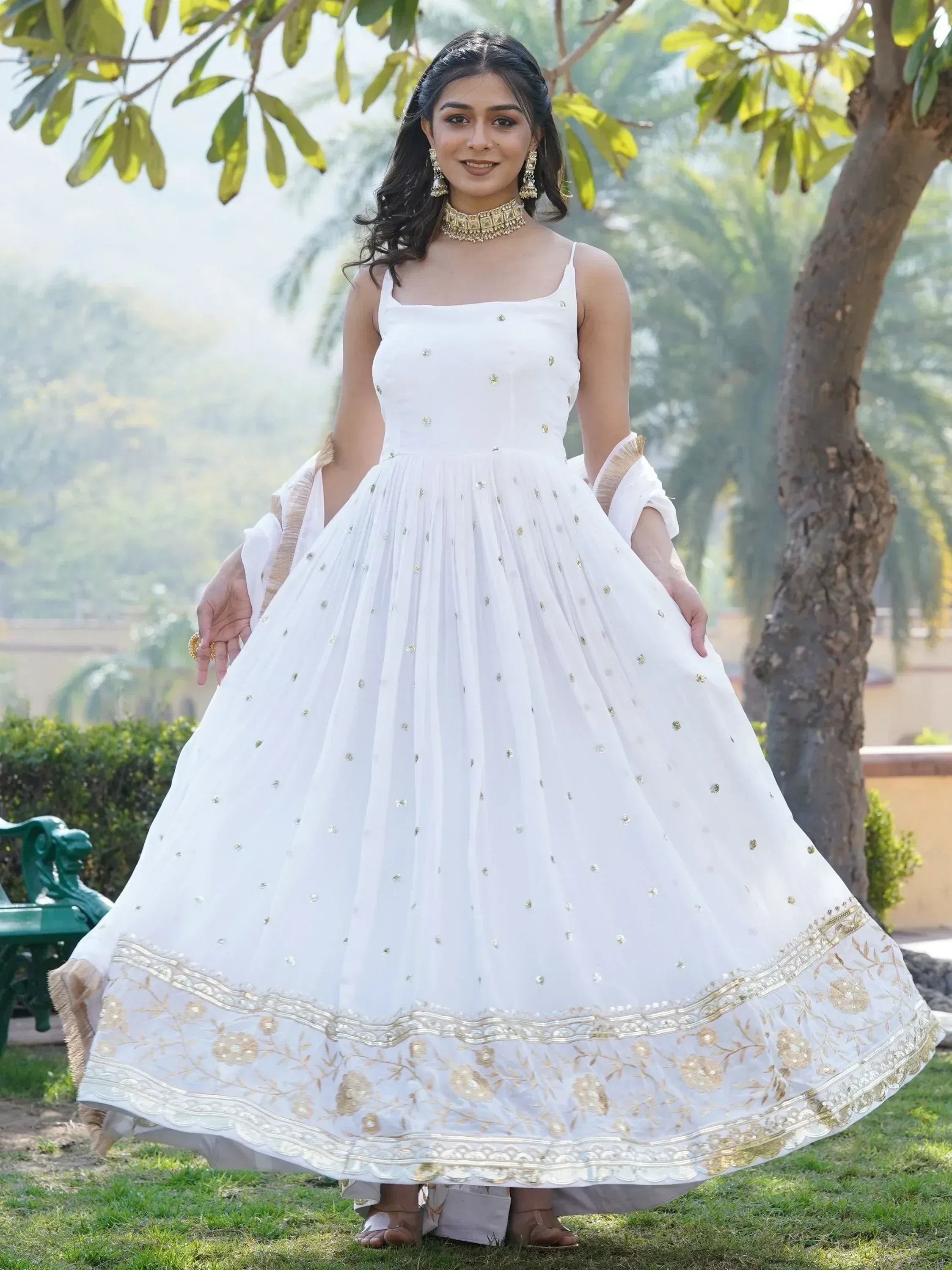 White ethnic gown with gold embroidery, perfect for Indian weddings and festive occasions