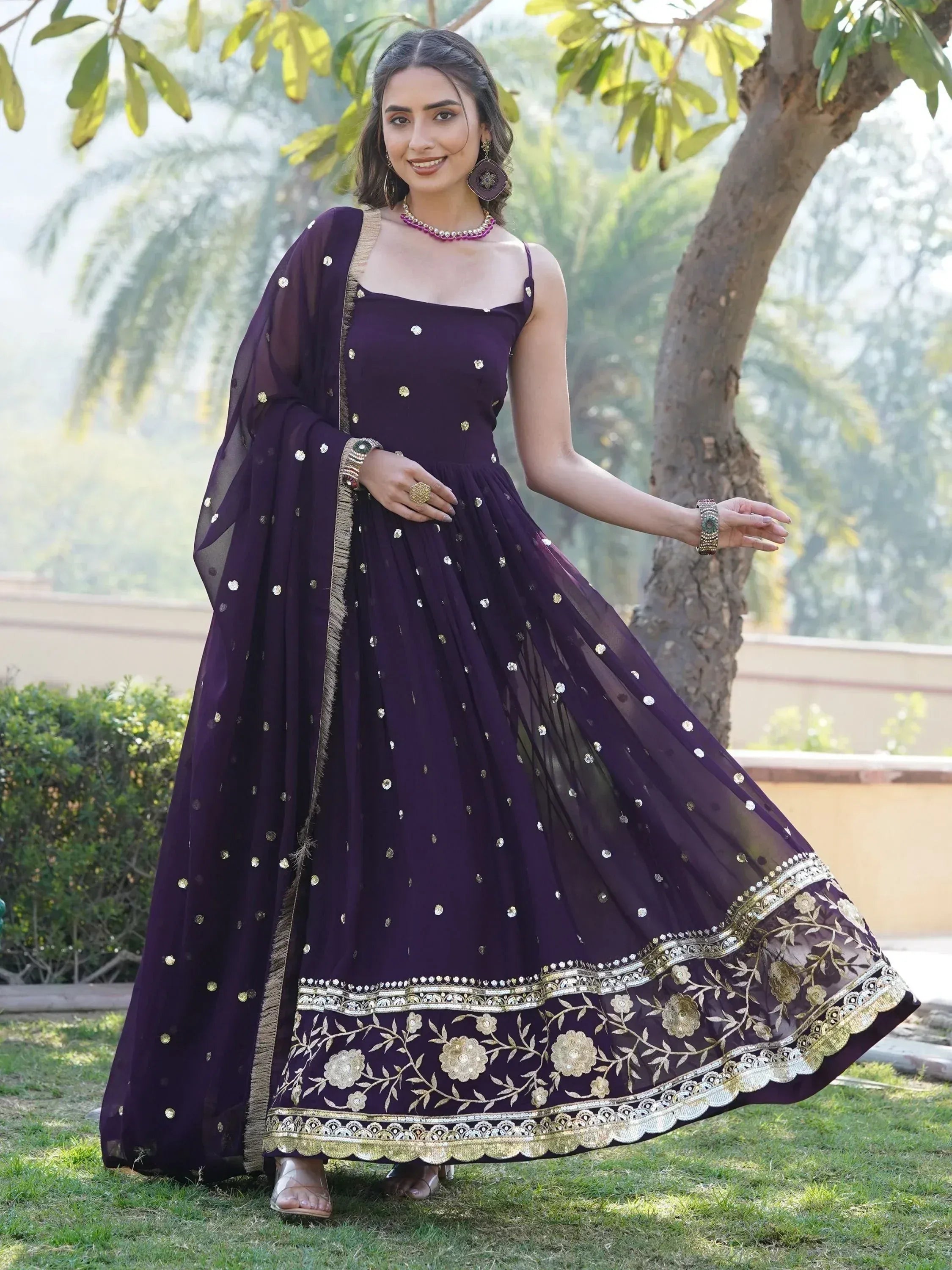 Purple ethnic gown with gold floral embroidery and sheer dupatta, perfect for Indian celebrations