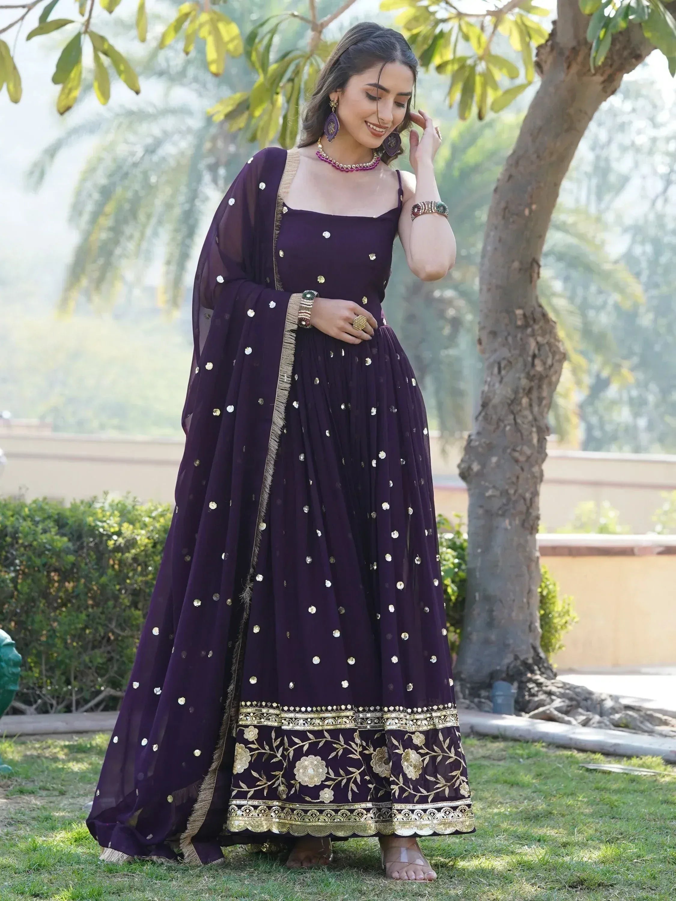 Purple ethnic gown with gold embroidery and mirror work, perfect for Indian occasions and festive wear.
