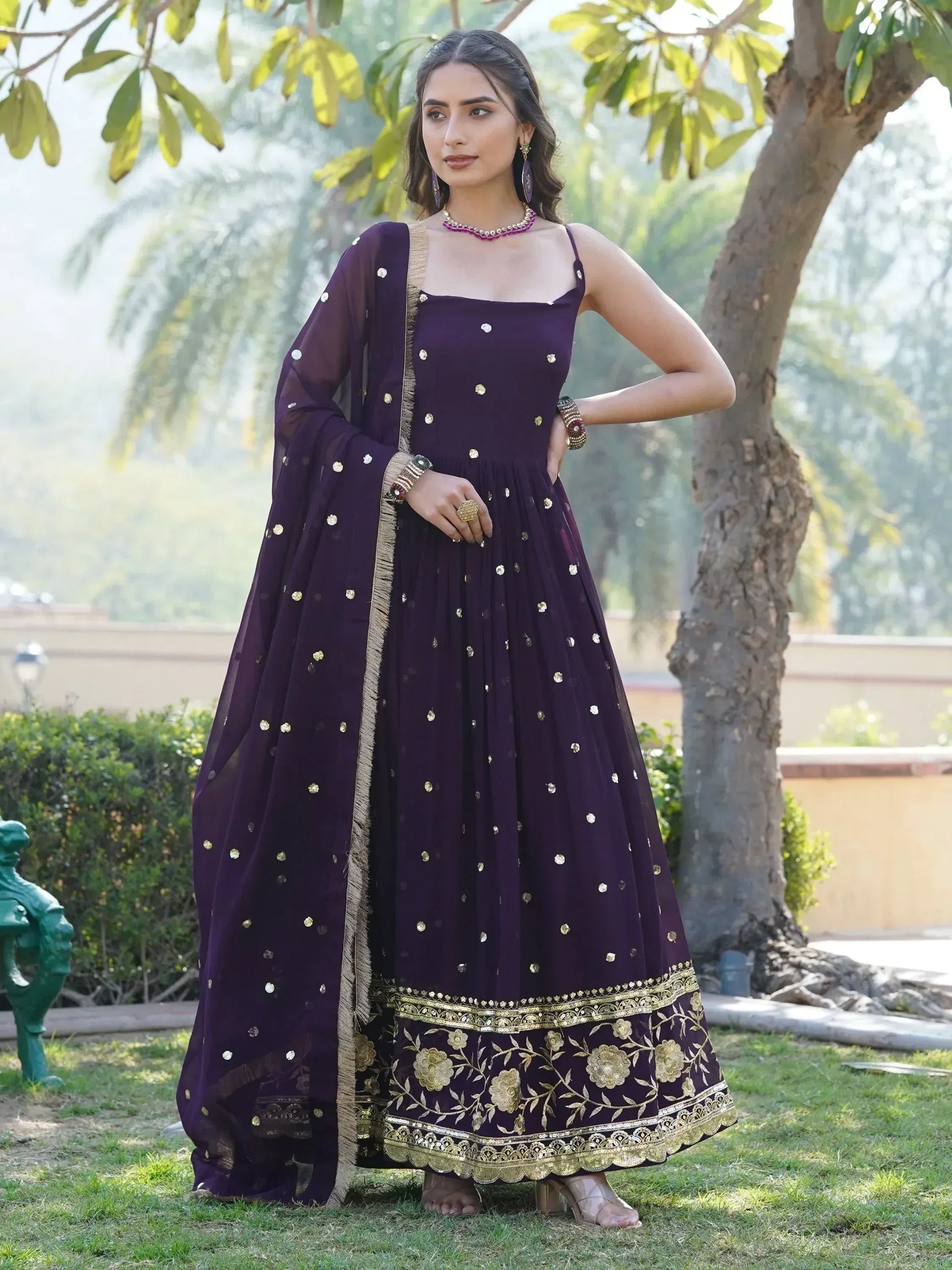 Purple Indian ethnic gown with gold embroidery and dupatta, perfect for weddings or festive occasions.