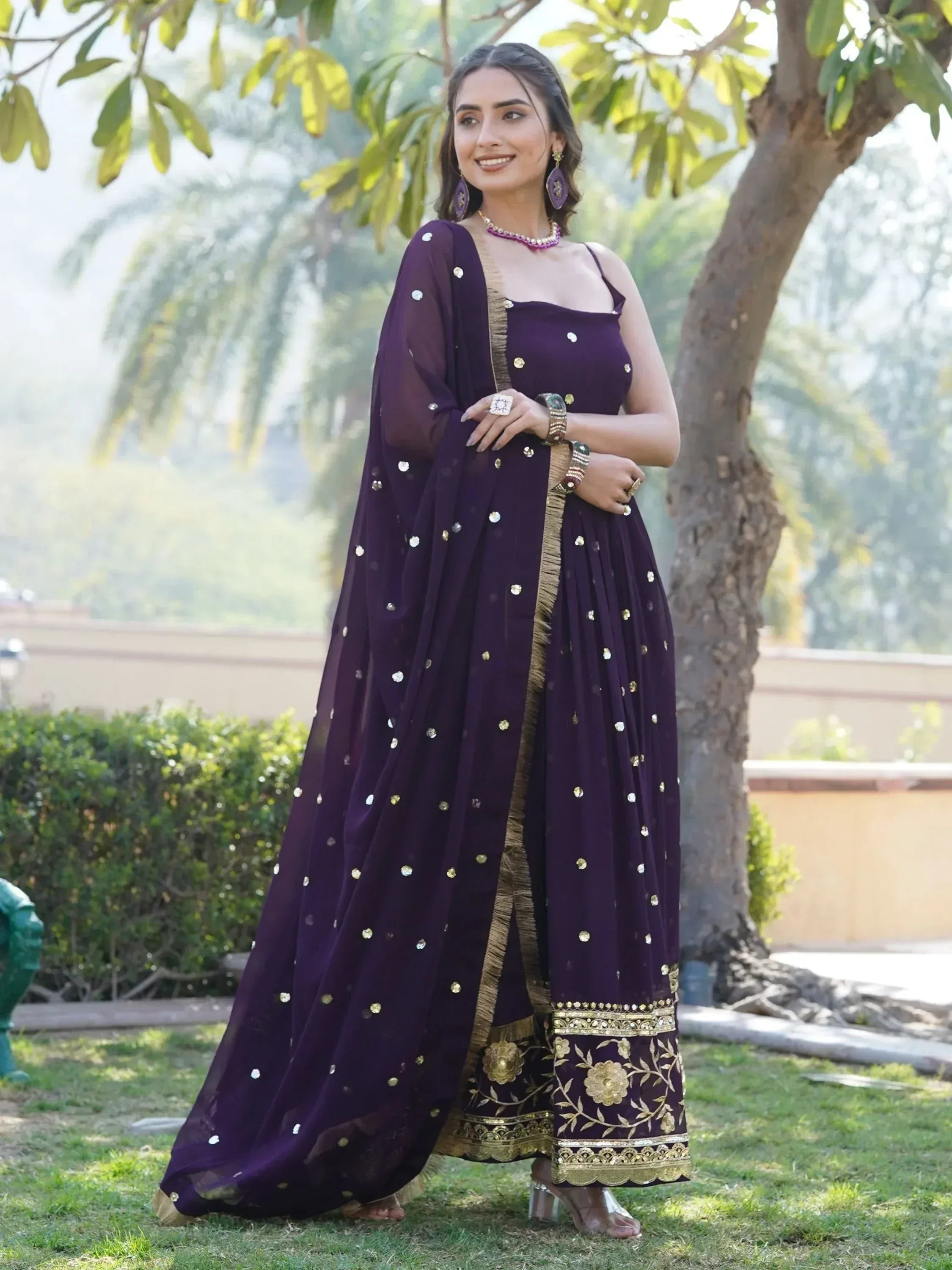Purple ethnic gown with gold embroidery and mirror work, perfect for Indian festive occasions