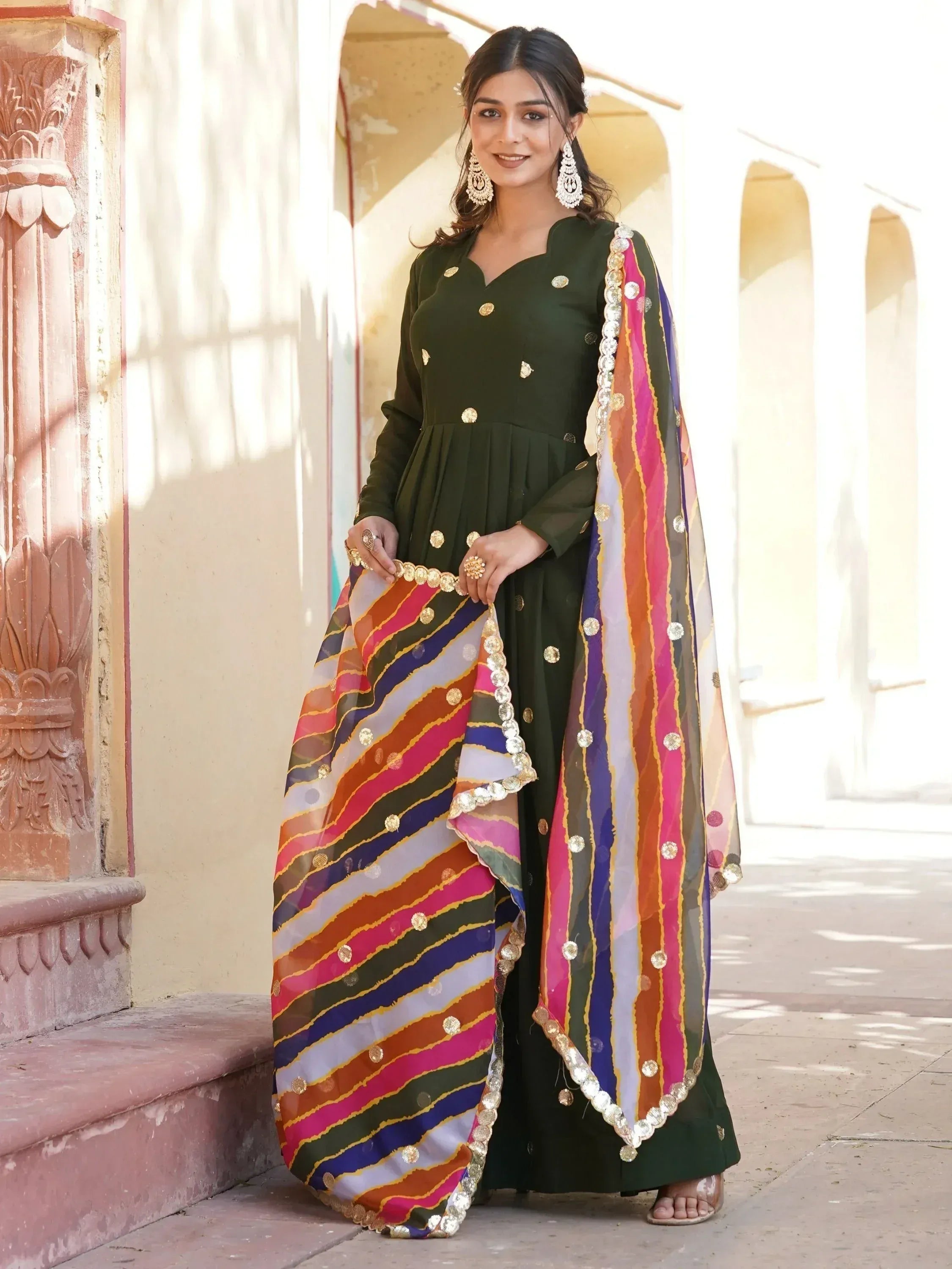 Green ethnic gown with colorful striped dupatta, perfect for Indian festive occasions and weddings.