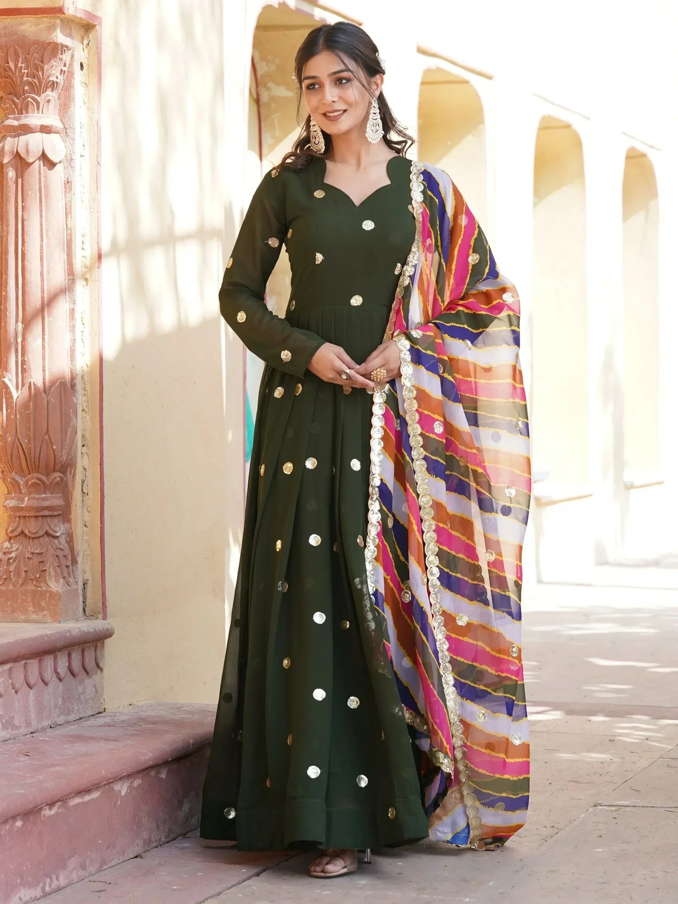 Green ethnic anarkali with gold mirror work and colorful striped dupatta, perfect for Indian occasions