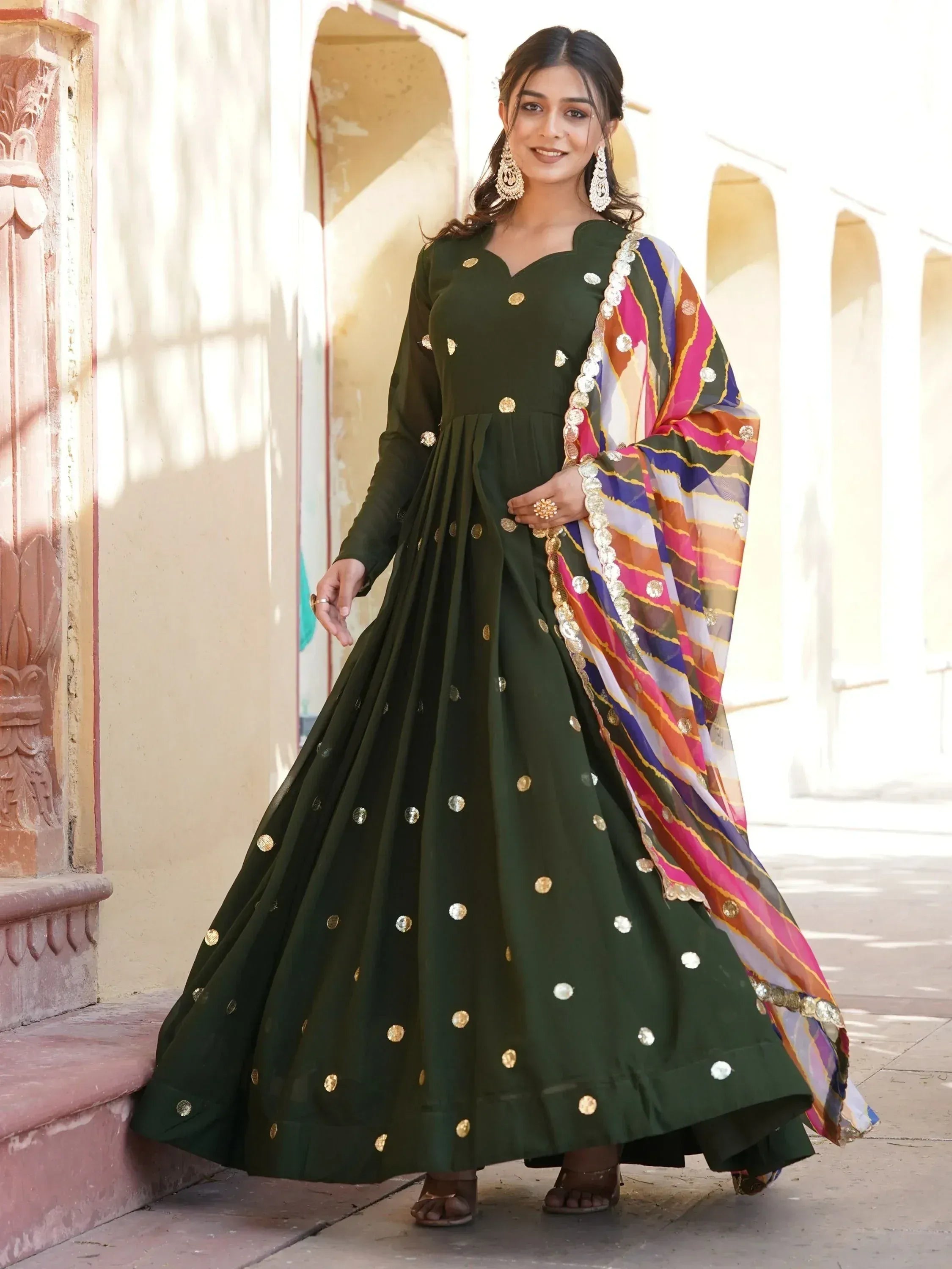 Green ethnic anarkali with gold embellishments and colorful dupatta, perfect for Indian occasions