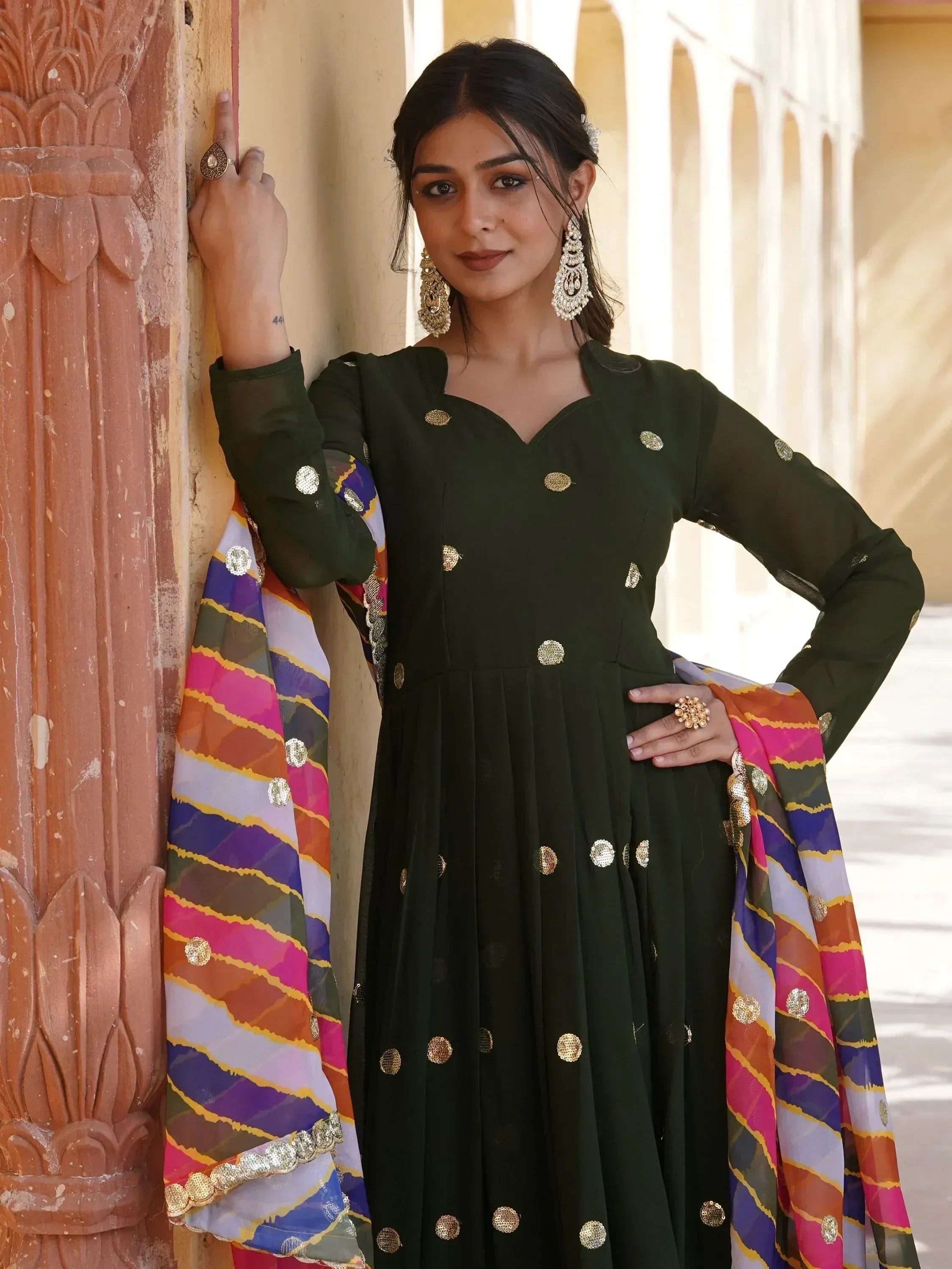 Woman in olive green anarkali with gold embellishments and colorful dupatta, traditional Indian ethnic wear