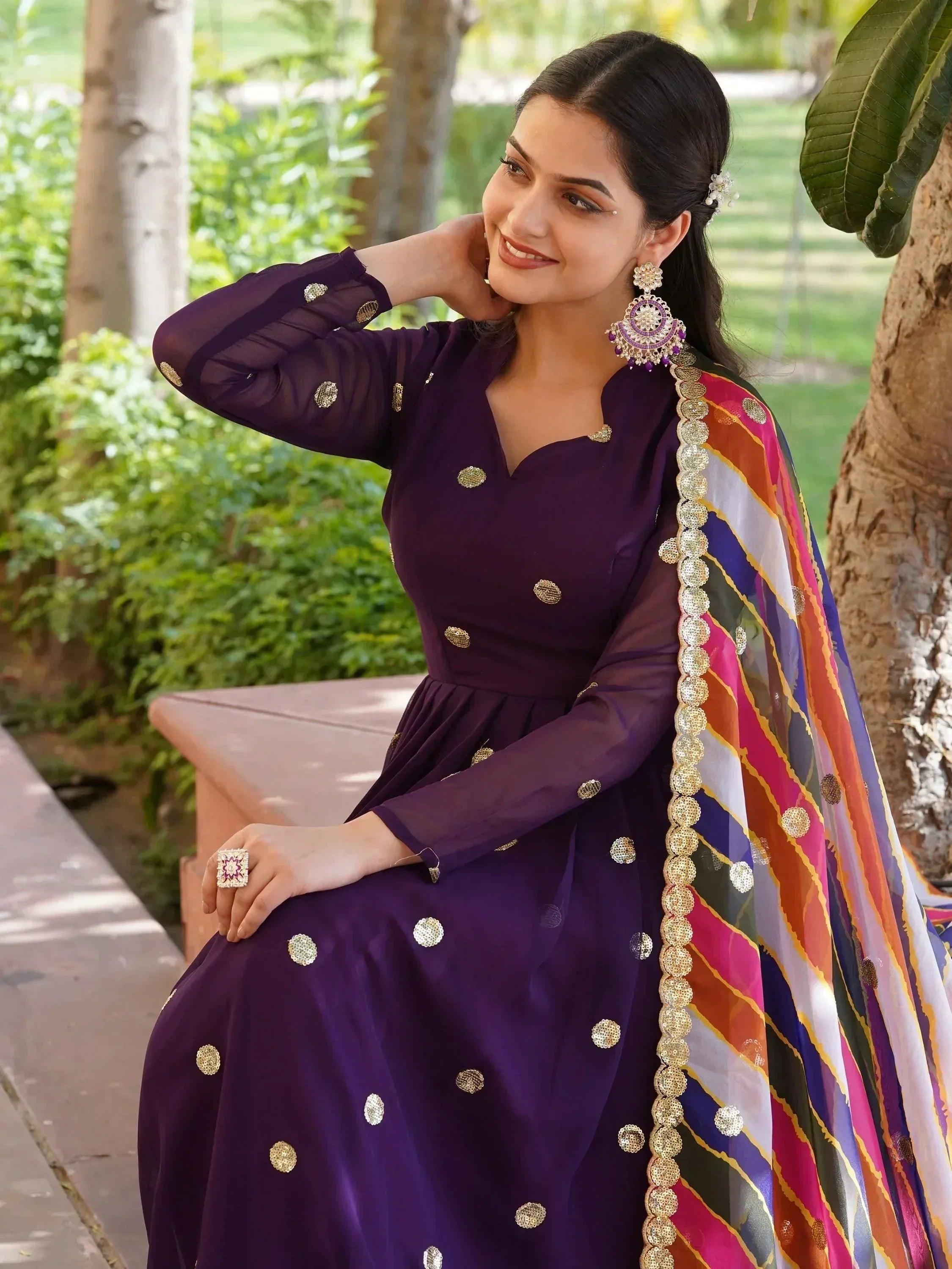 Purple ethnic gown with gold embroidery and colorful dupatta, perfect for Indian festive occasions