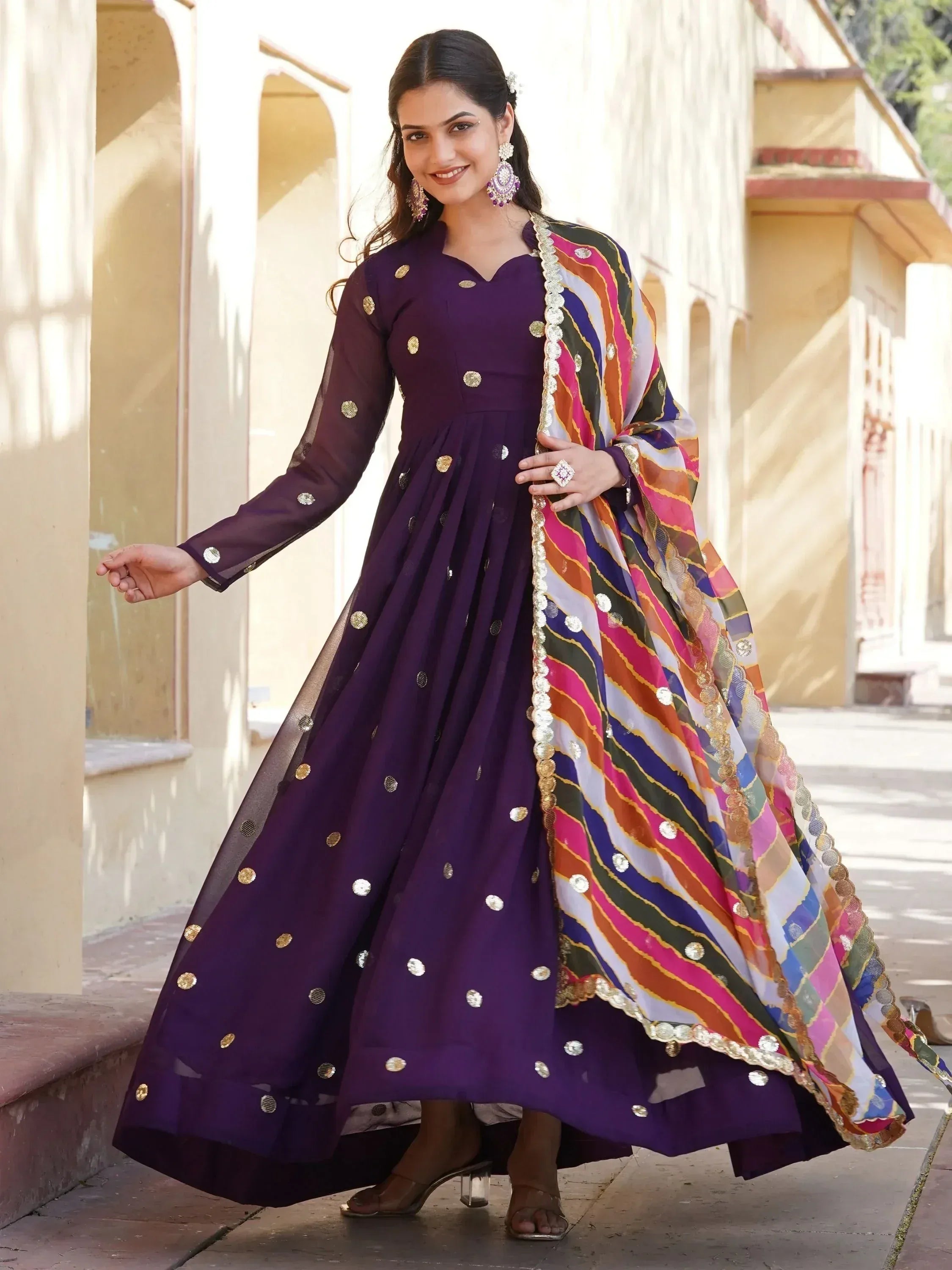 Purple ethnic anarkali with gold mirror work and colorful striped dupatta, perfect for Indian occasions