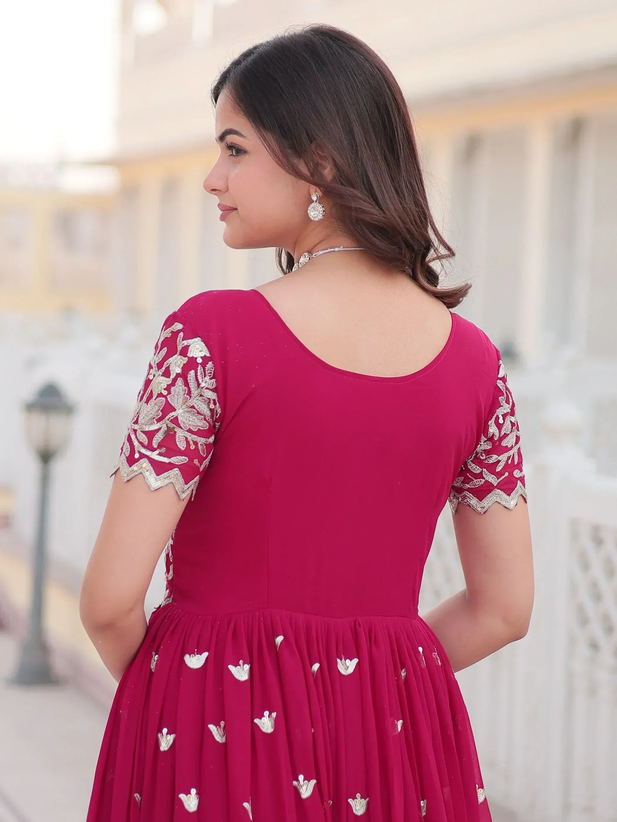Woman in maroon ethnic gown with silver embroidery, perfect for Indian occasions and parties