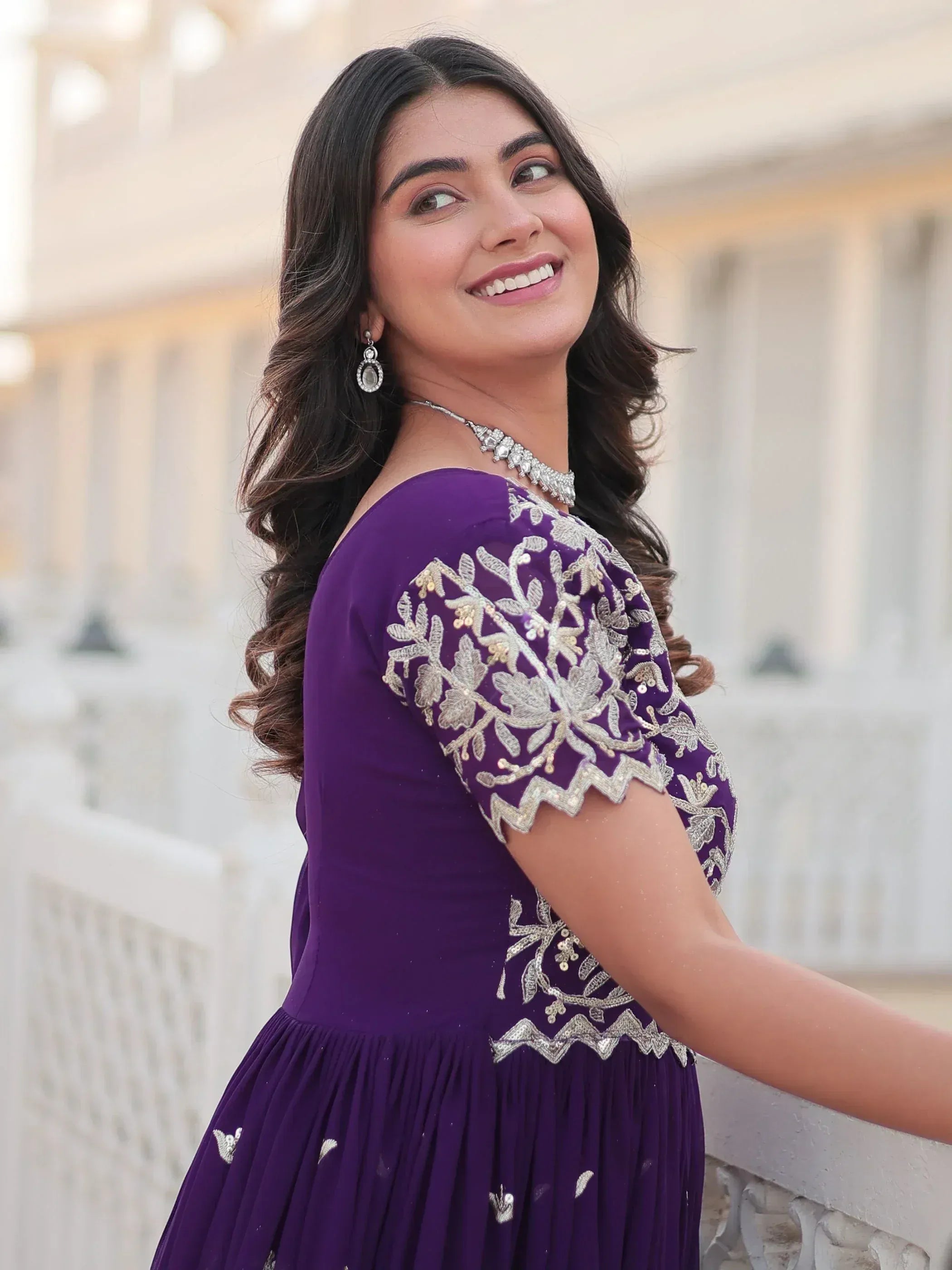 Woman in purple ethnic gown with silver embroidery, perfect for Indian occasions and weddings