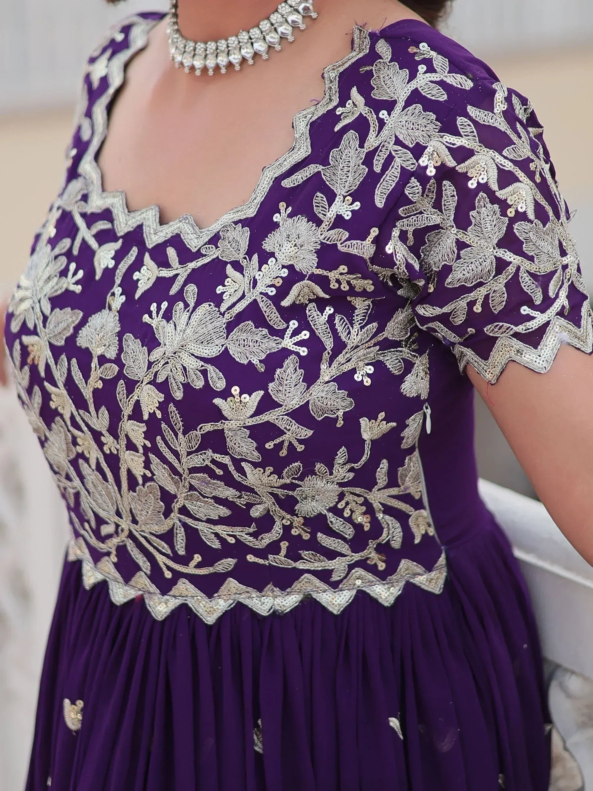 Purple ethnic gown with silver floral embroidery and sequins, perfect for Indian occasions.