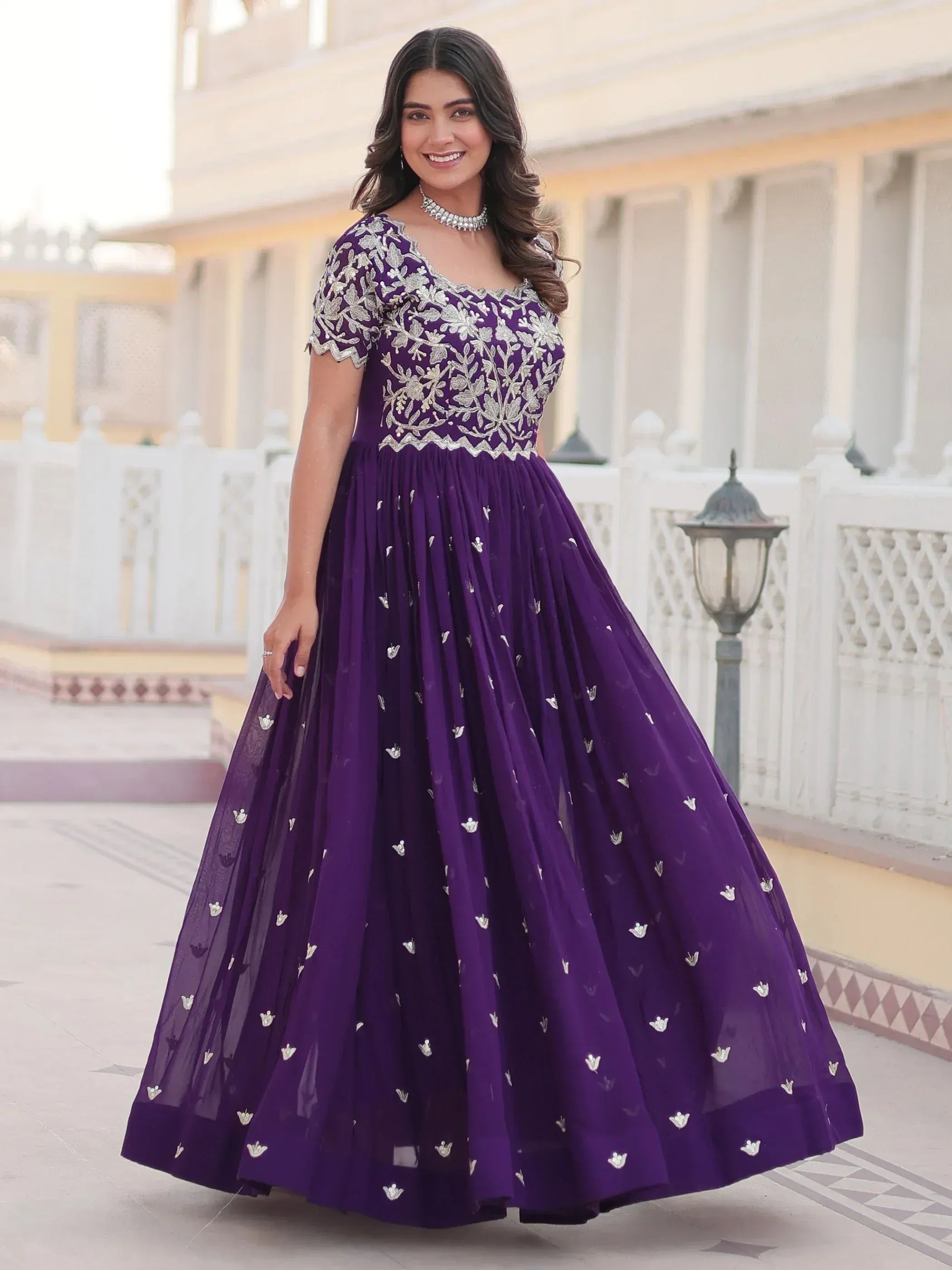 Purple embroidered ethnic gown with floral detailing, perfect for Indian occasions and festive wear.